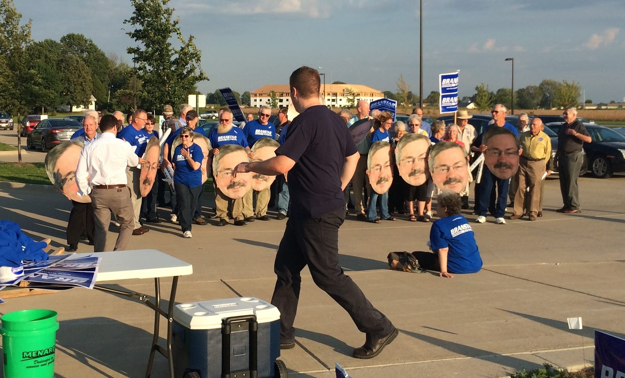 Republican supporters of Gov. Terry Branstad, holding large posters bearing the likeness of his face, pose for a group photo before the Sept. 20 gubernatorial debate in Burlington, Iowa.
