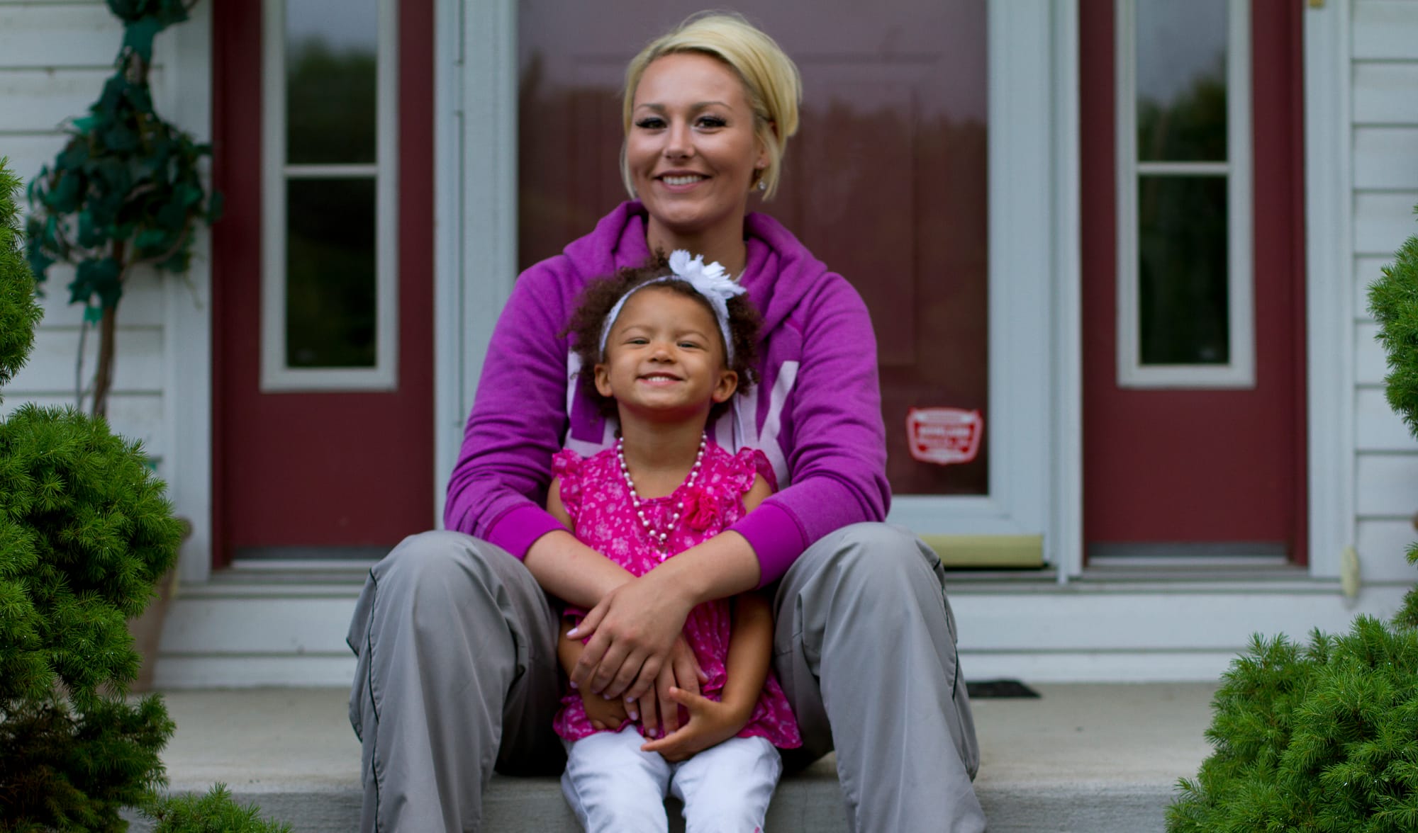 Army veteran Briana Hawkes, 25, sits with her daughter Aubrey, 3, outside Hawkes' parents' home in Bristolville, Ohio. When Hawkes was deployed, Aubrey “was trying to reach her hands out to hold me or for me to pick her up and I was like, ‘I can’t!’ It’s hard for you to explain something like that to a 1-year-old child,” she said. "But now she’s used to it, she understands a lot more.”