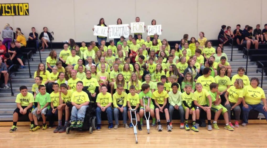 Cael Rudkin's West Marshall elementary school classmates at a September 2014 fundraiser. They wore shirts that read, "Fight for Cael" to school on a Friday. This was in preparation for the Beaverdale Beaverdash, a run every fall in Des Moines that is a fundraiser for CureSMA, an organization for families with a child with Spinal Muscular Atrophy (SMA). 