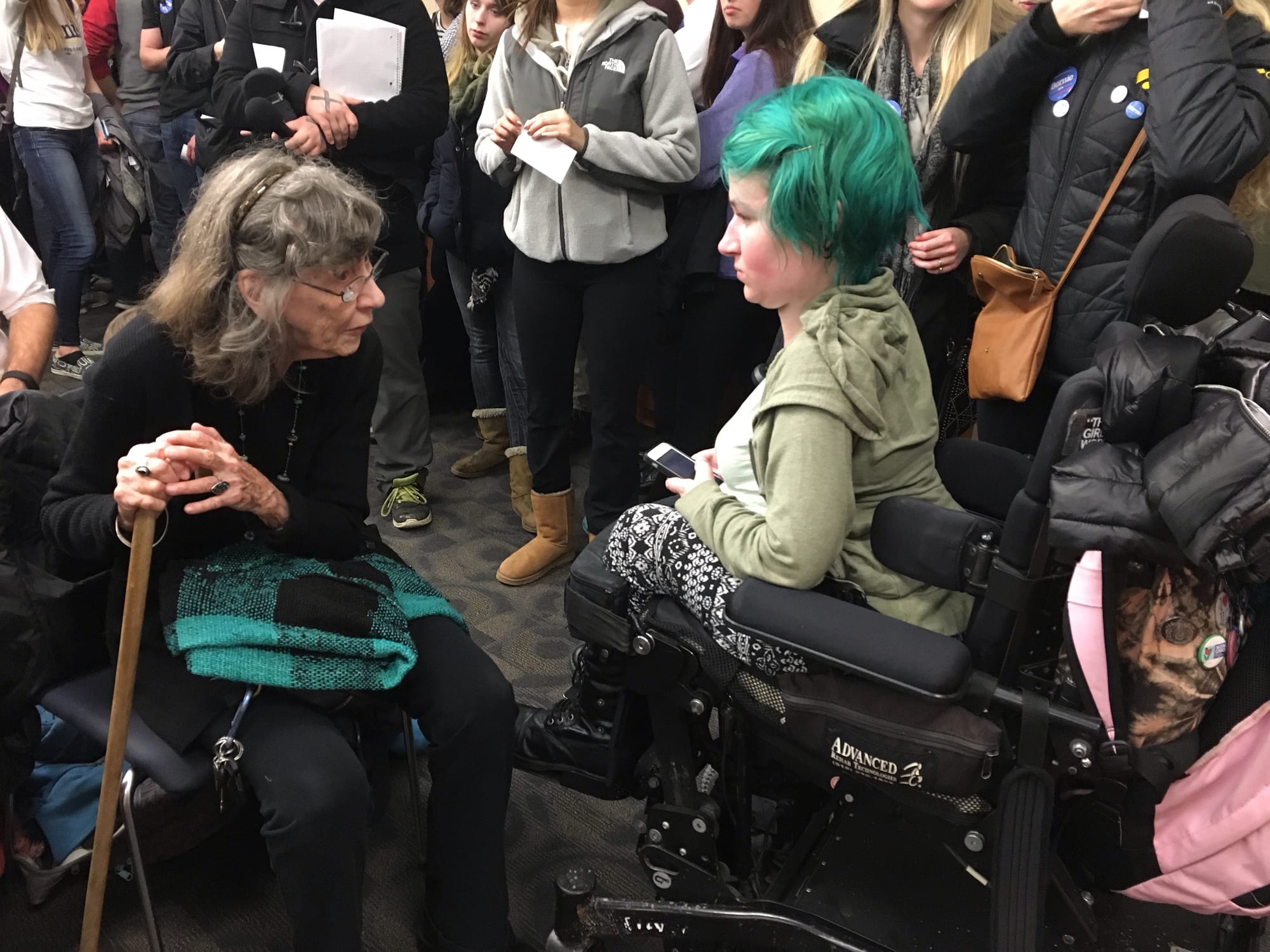 IowaWatch reporter Hannah Soyer (r) while interviewing Democrats at an Iowa City, Iowa, precinct caucus the night of Feb. 1, 2016.