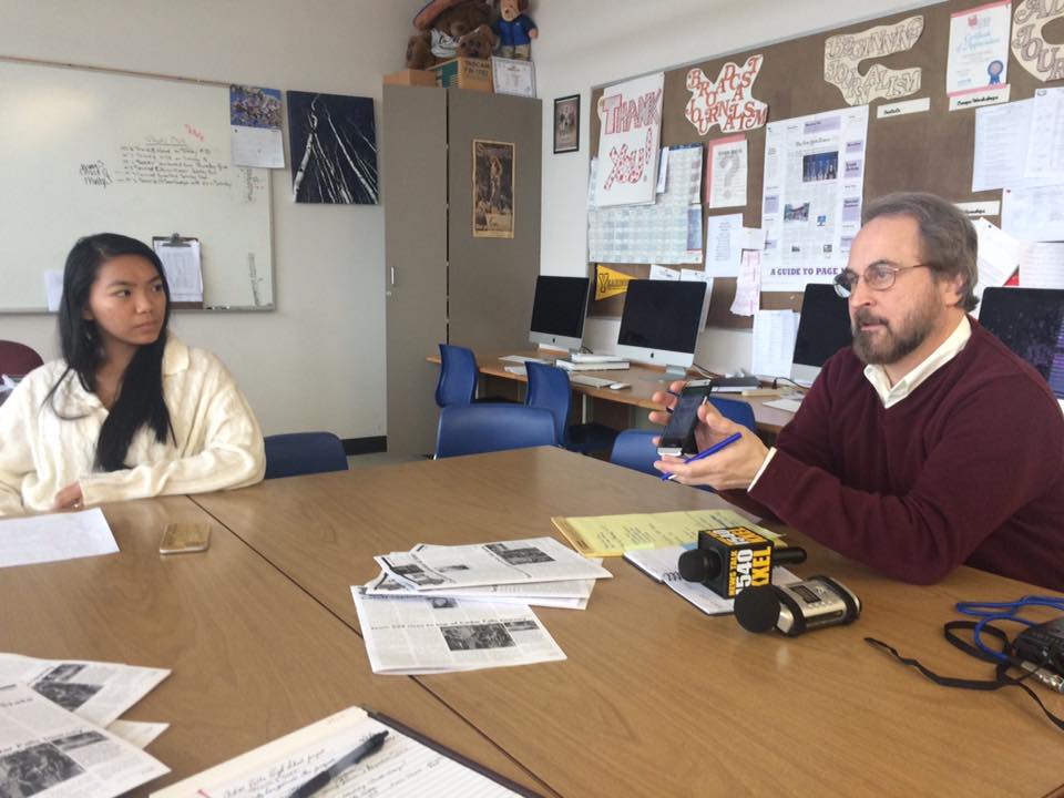 Cedar Falls High School Tiger Hi-Line reporter Tana Gam-ad listens on March 31, 2016, while IowaWatch Connection host and KXEL radio station manager Jeff Stein explains best practices for getting broadcast audio. Tiger Hi-Line students collaborated with IowaWatch in the pilot program that a Community Foundation of Johnson County grant will help expand in 2017.