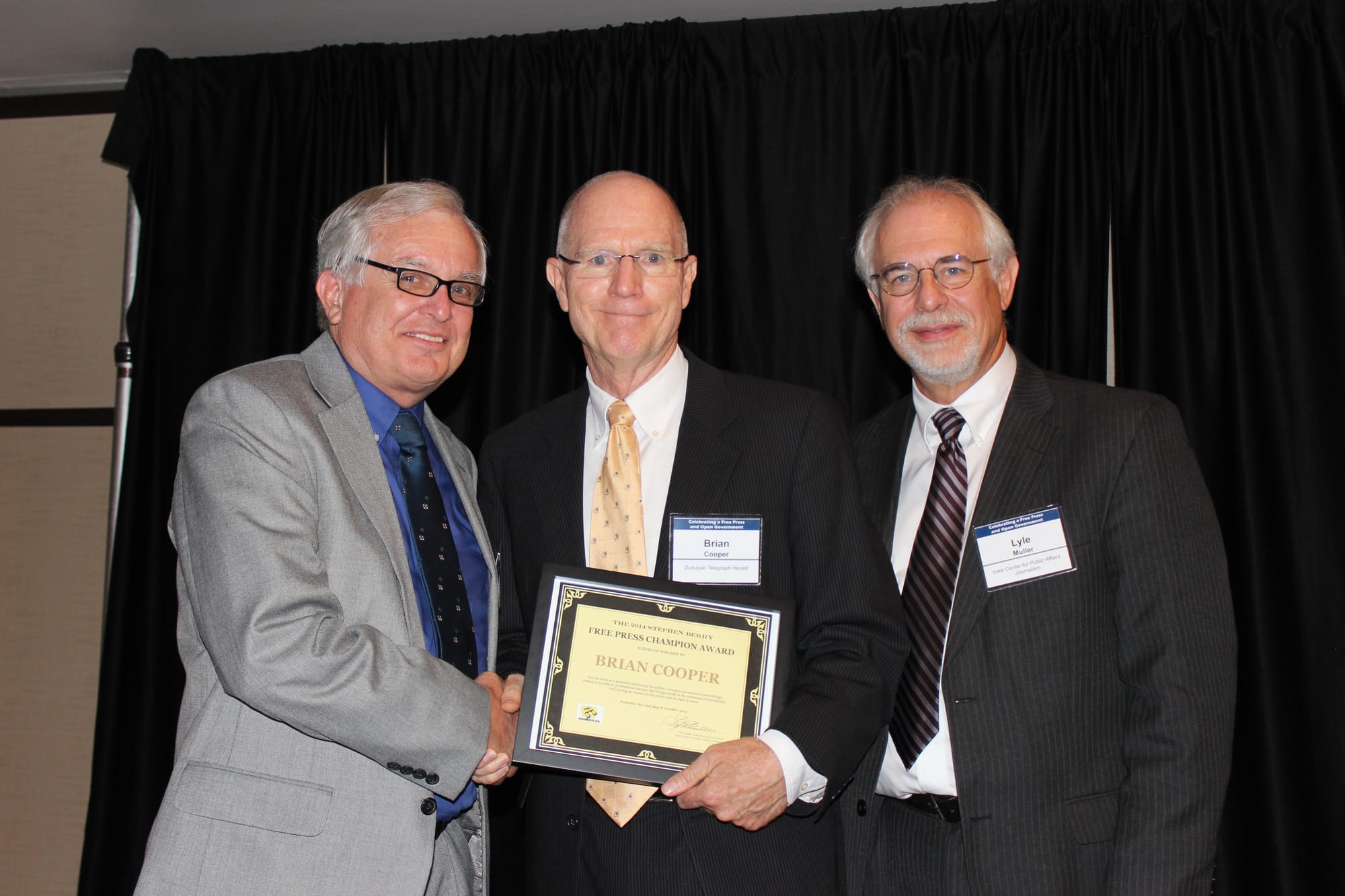 Telegraph Herald executive editor Brian Cooper receives IowaWatch's Stephen Berry Free Press Champion Award at the annual Celebrating a Free Press and Open Government Banquet, in Des Moines on Oct. 2, 2014, With Cooper are (left) IowaWatch cofounder Stephen Berry and (right) IowaWatch executive director-Editor Lyle Muller.