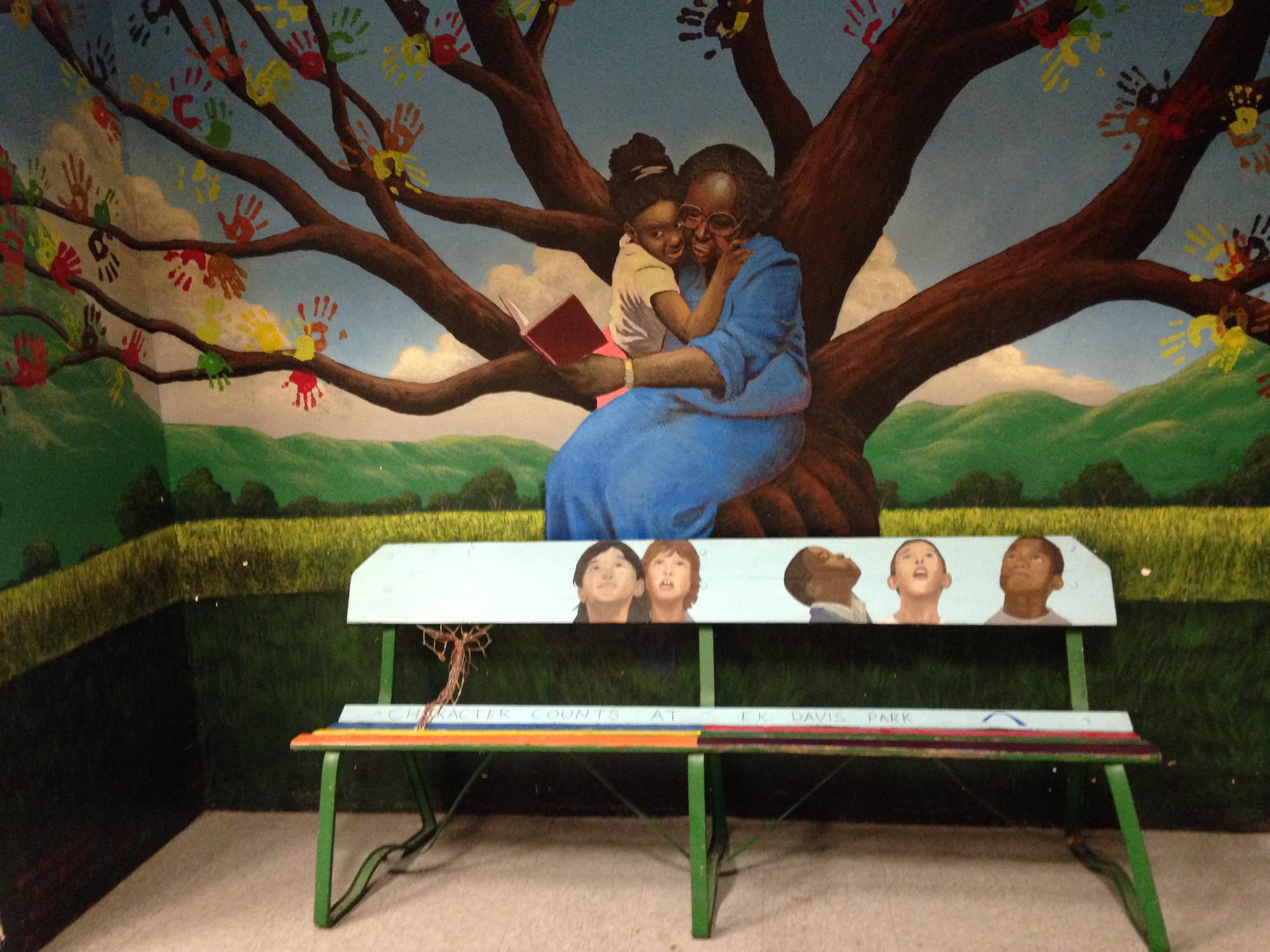A mural at Creative Visions in Des Moines illustrates the organization's mission of reducing violence and bringing neighborhoods together.