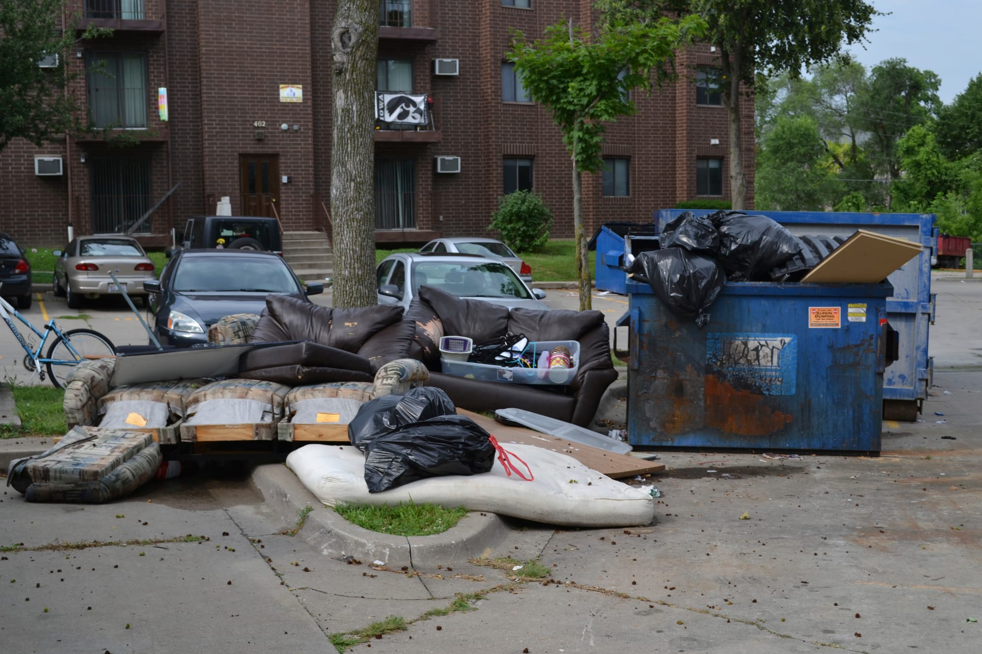 Dumpsters off of Gilbert Street in Iowa City overflow with furniture and trash as University of Iowa students move out on July 28, 2015. Leases for students typically expire July 31 each year.