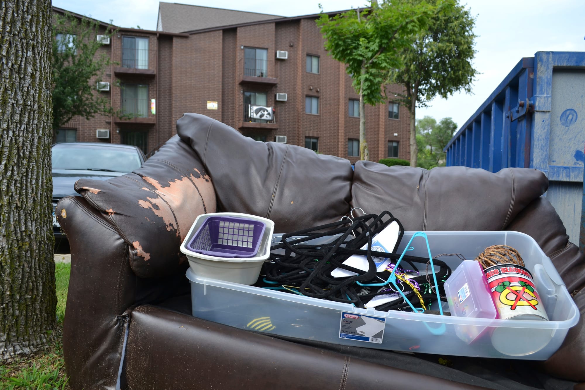 Dumpsters off of Gilbert Street in Iowa City overflow with furniture and trash as students move out on July 28, 2015. Most leases for apartments college students in Iowa City rent expire July 31, creating a massive amount of moving, dumping old furniture and fighting over getting back damage deposits.