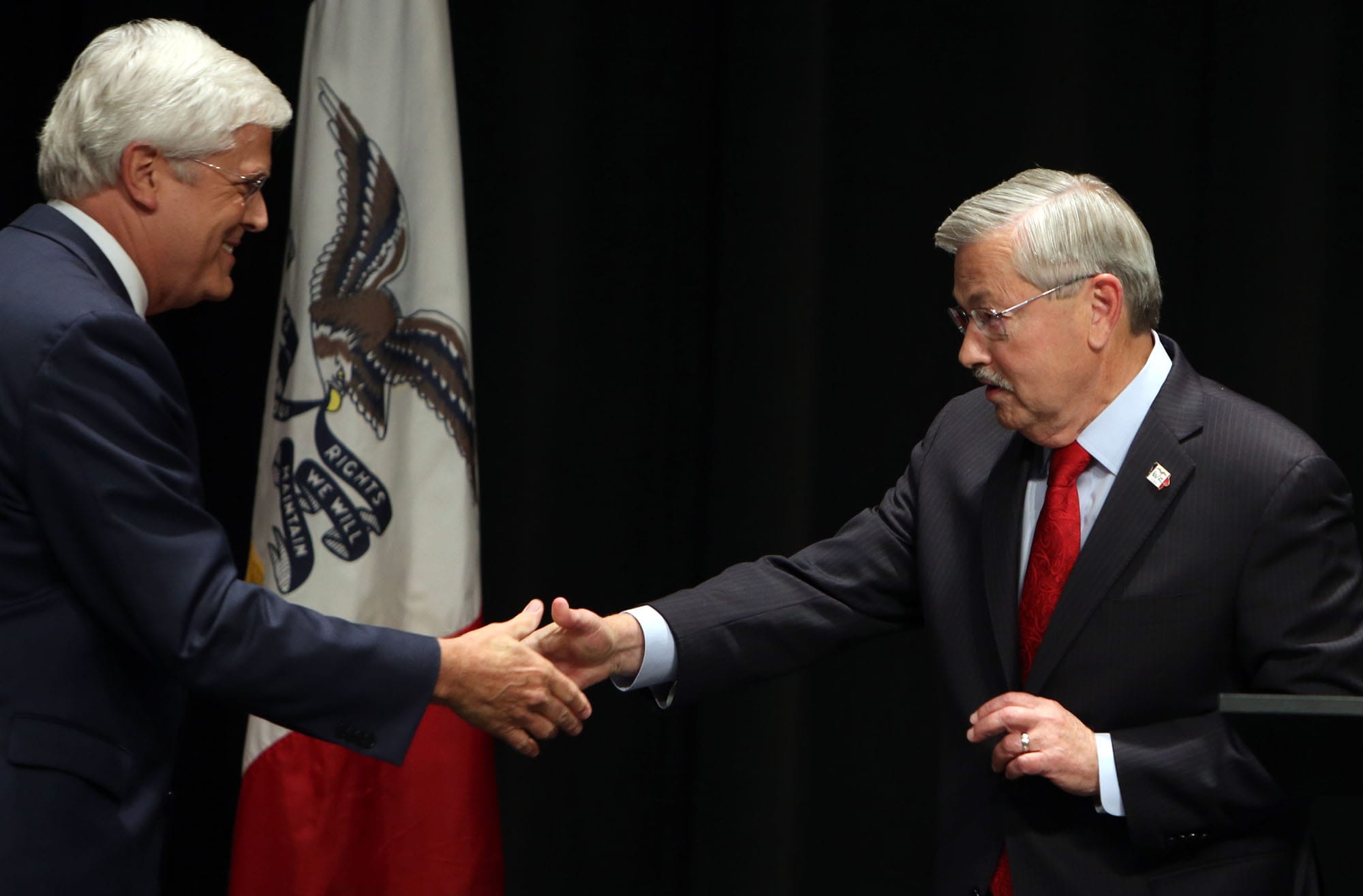 Iowa Gov. Terry Branstad and Iowa Sen. Jack Hatch greet each other at the start of their debate on economic development and job growth Saturday September 20, 2014 at Edward Stone Middle School in Burlington, Iowa. The 2nd Iowa Gubernatorial Debate was sponsored by The Hawk Eye newspaper, KWQC TV and The Greater Burlington Partnership.