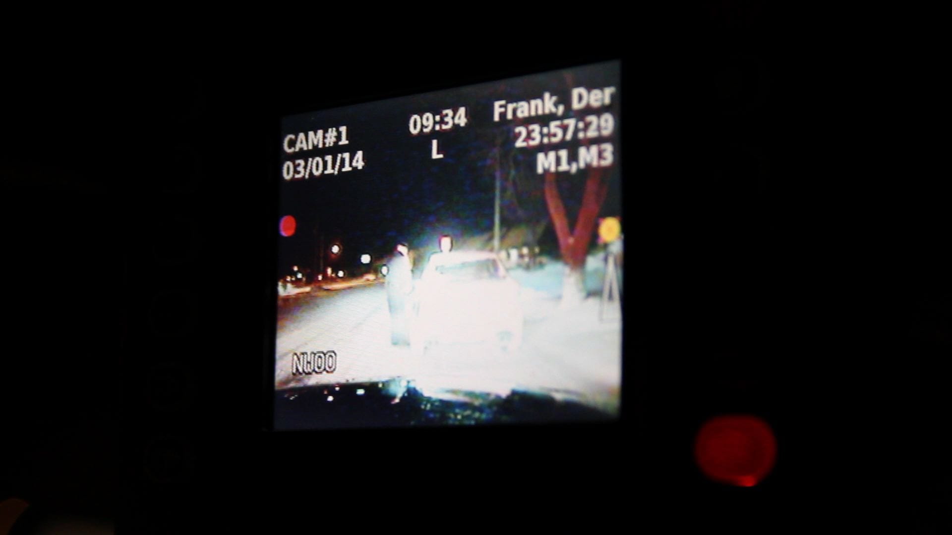 Iowa City Police Officer Derek Frank stops a taxicab driver in downtown Iowa City the night of March 1, 2014. This photo shows the image produced by a video camera that is taping the stop.