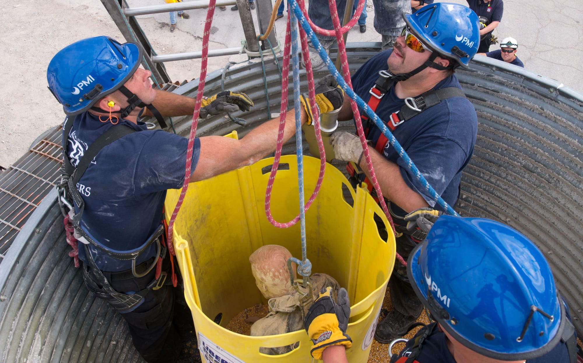 Firefighters practice placing a rescue tube during grain bin rescue training at the Danville, Ill., Bunge facility on Tuesday, Sept. 17, 2013.