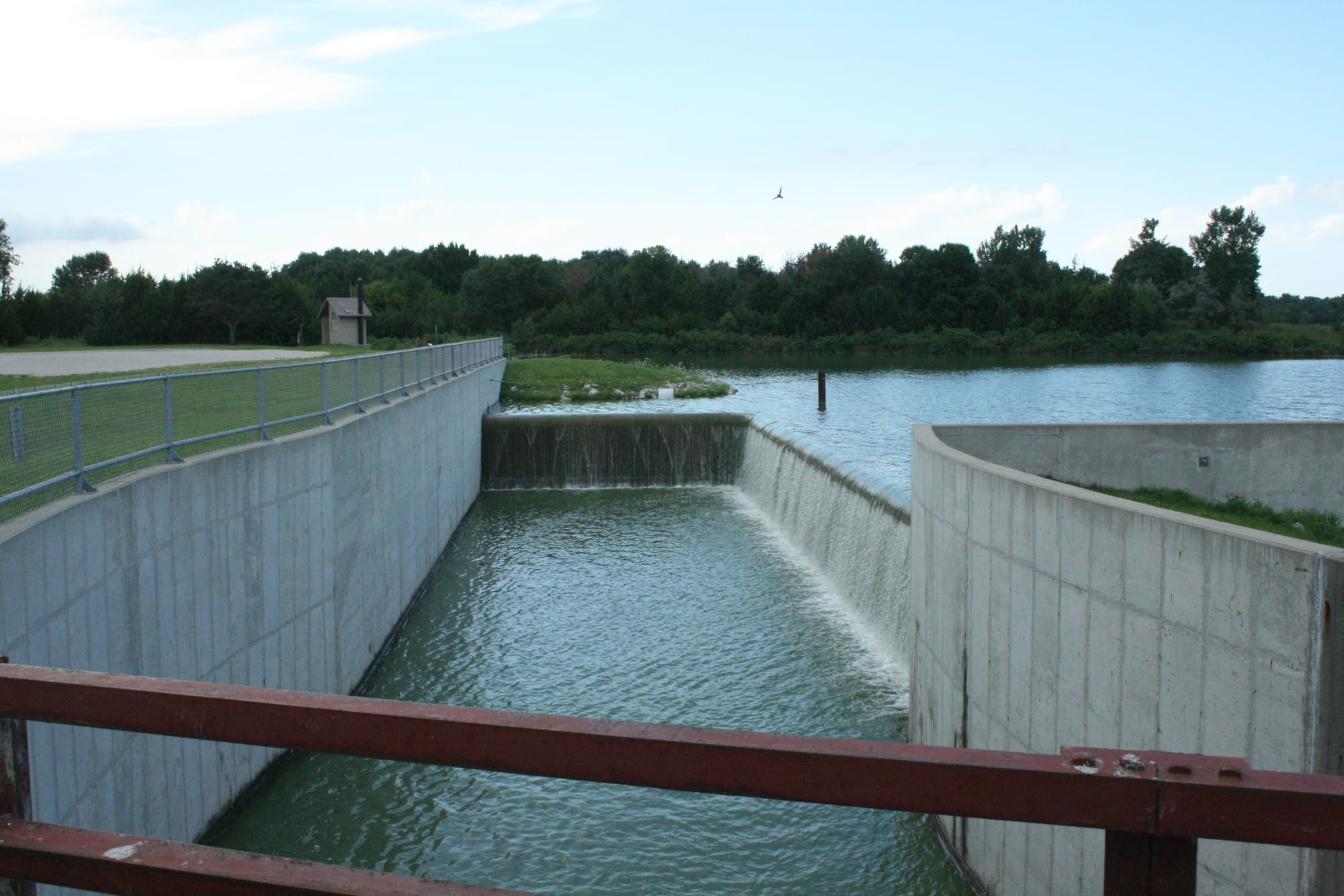 The Green Valley Lake spillway, pictured July 31, 2015, at the south end of the lake was rebuilt in 2009 as part of a lake restoration project. The previous spillway had developed structural problems and allowed common carp, a fish that contributes to poor water quality conditions, to enter the lake.