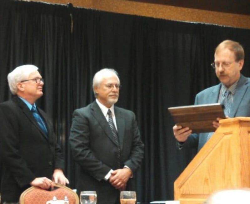 IowaWatch co-founder Stephen Berry (left) and executive director-editor Lyle Muller receive the 2014 Excellence in Journalism Award from the Iowa Association for Justice's executive director, Brad Lint, on Nov. 5, 2014, in Des Moines.