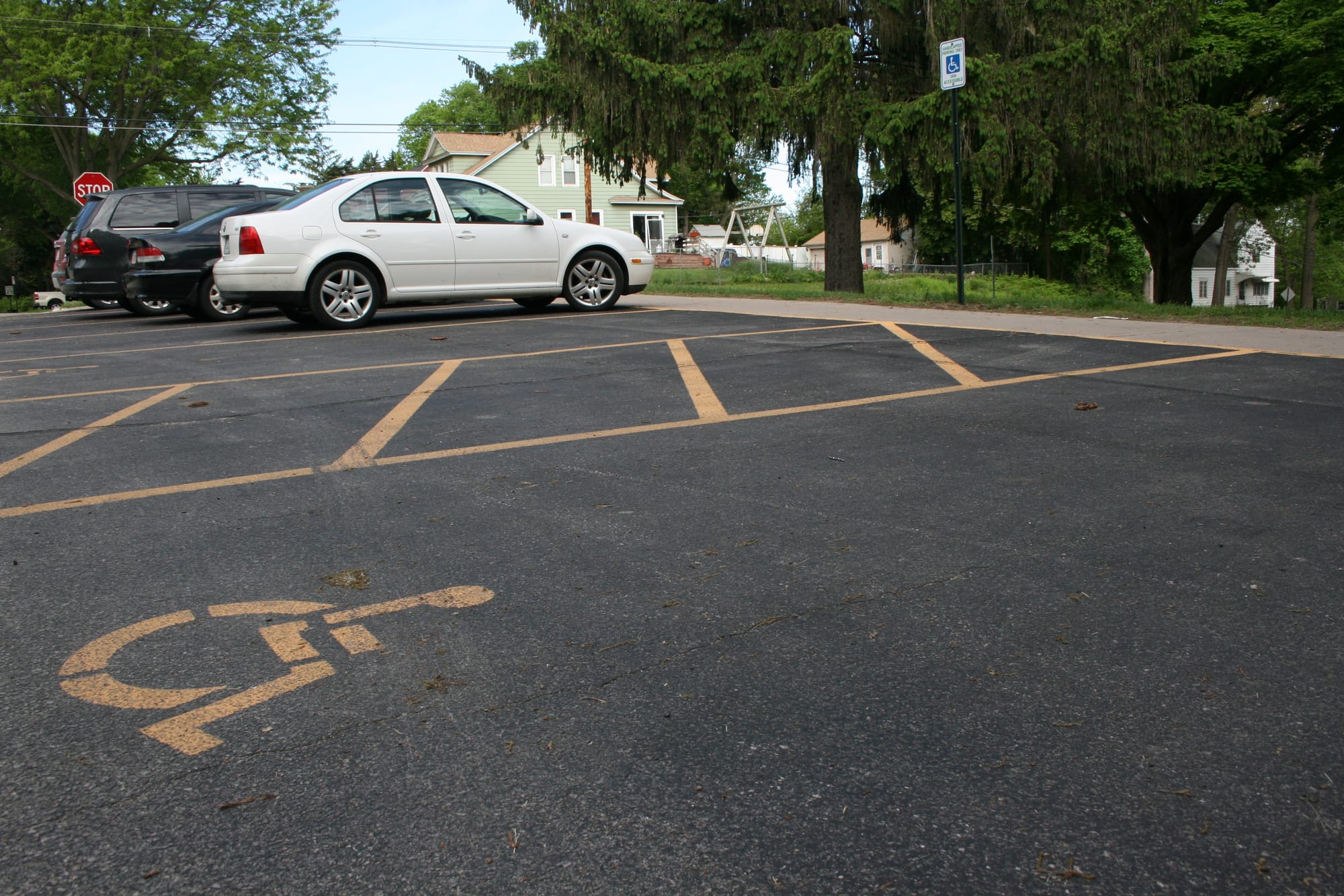 Markings and signage for a handicapped-accessible parking space and a loading zone outside a Cedar Rapids school on May 12, 2016.