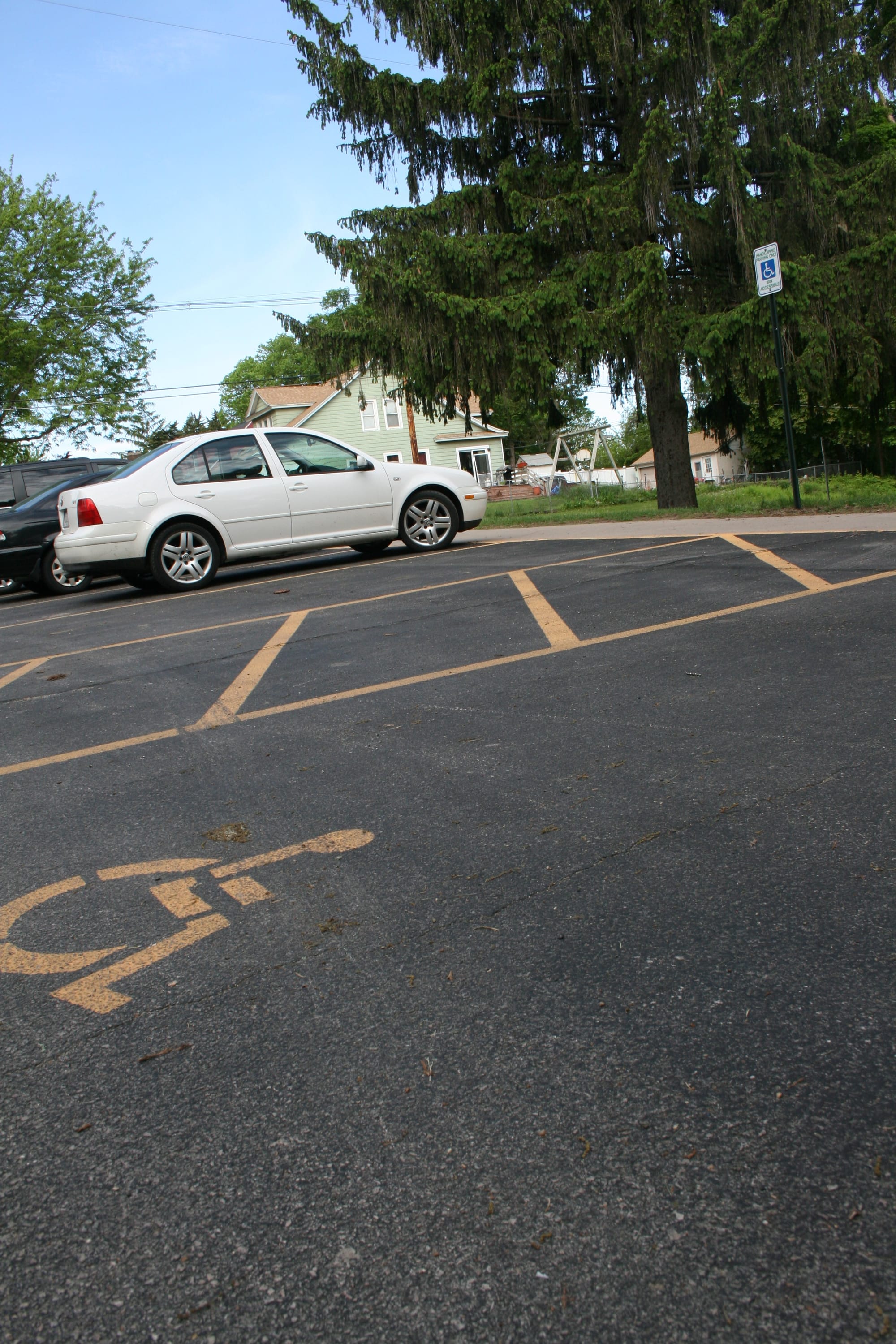 Markings and signage for a handicapped-accessible parking space and a loading zone are shown outside a Cedar Rapids school on May 12, 2016.