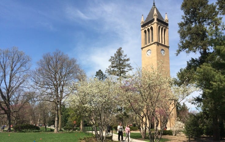 Students walk by the iconic Iowa State University Campanile tower on April 16, 2015.