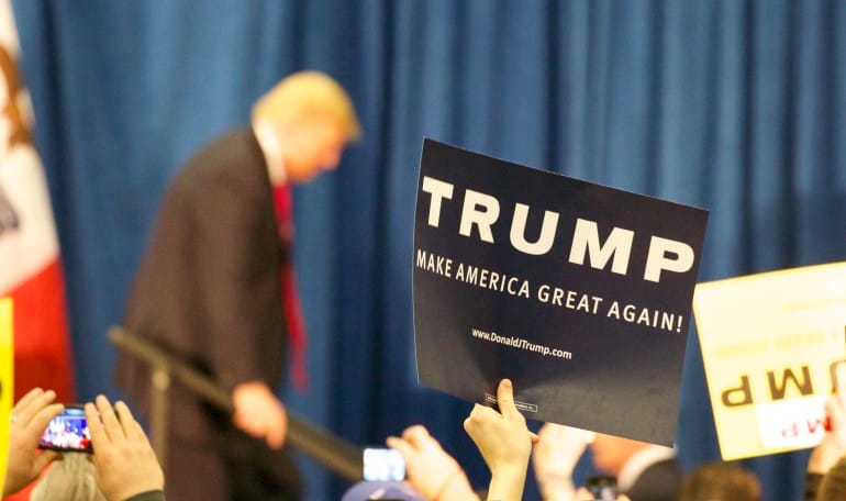 Signs show the hopes Donald Trump expressed for winning the Iowa Republican presidential precinct caucuses during this campaign stop at the University of Iowa Field House on Tuesday, Jan. 26, 2016.