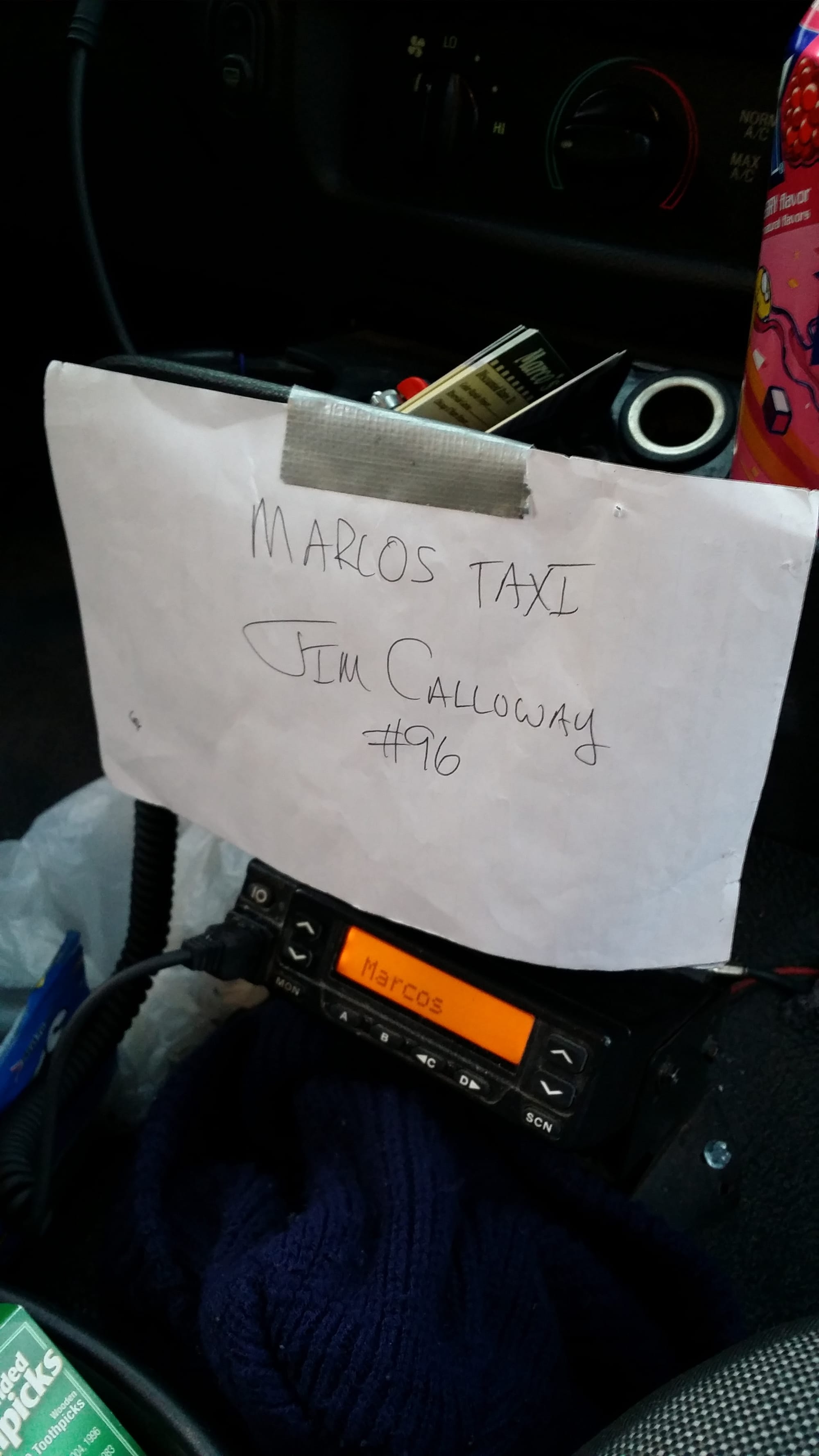 Marcos Taxicab driver Jim Calloway displays a makeshift taxi identification card at the front of a cab he is driving April 7. This is all Iowa City requires for driver identification.