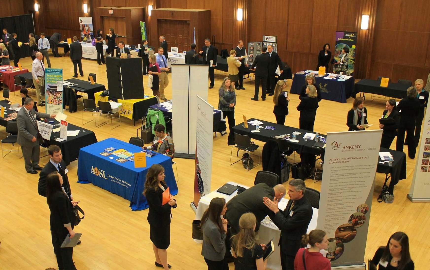 Graduating seniors seeking jobs meet with company recruiters at a University of Iowa job fair on March 8, 2013.