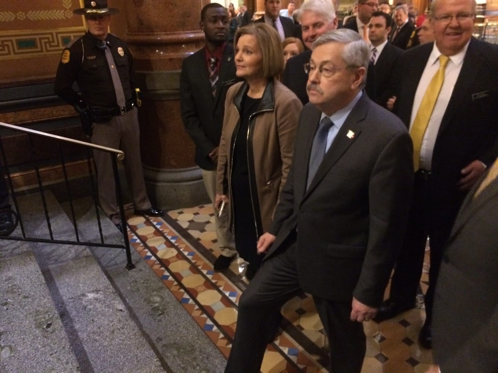 Iowa state Sen. Liz Mathis, D-Robins, helps escort Gov. Terry Branstad into the Iowa House chamber for Branstad's annual Condition of the State address on Jan. 10, 2017.