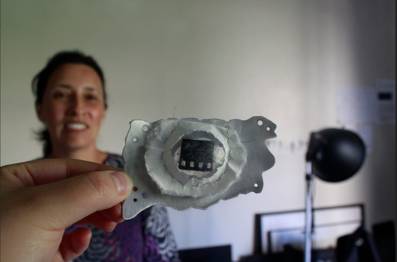 Patricia Leon and one of the pieces of art she has produced in a jewelry and metal arts course she took in 2012 at the University of Iowa's School of Art and Art History. Leon is an accomplished photographer in her home country of Columbia but has put that career on hold while her husband is a graduate student at the UI.