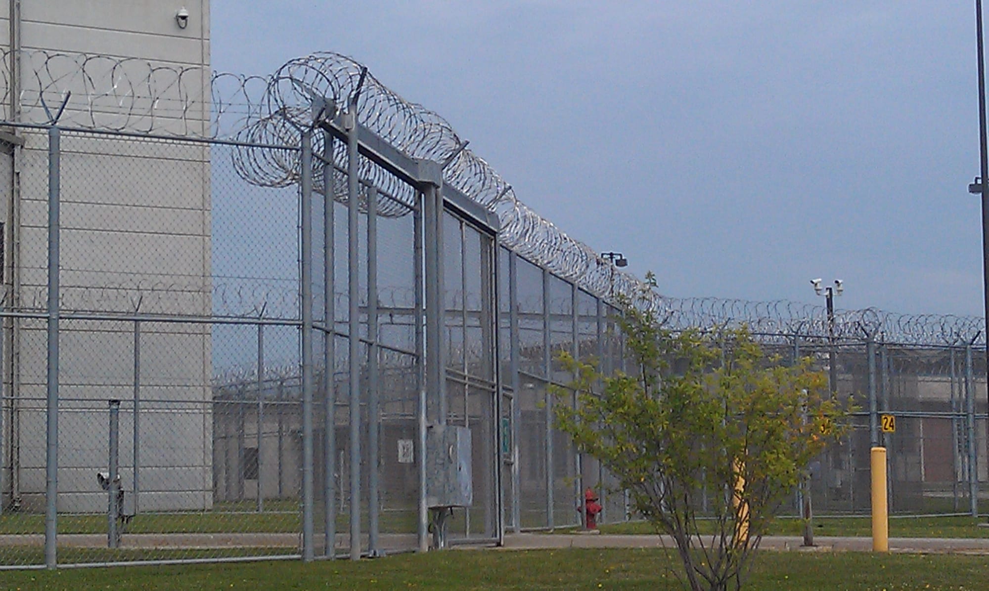 A mix of barbed wires and fencing is designed to maintain security at the Iowa Medical and Classification Center in Coralville.