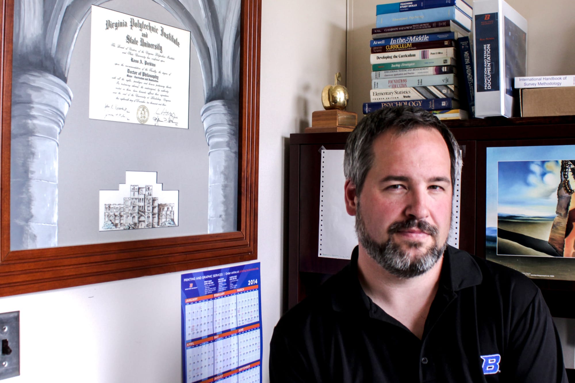Boise State University associate professor Ross Perkins poses next to his doctorate diploma from Virginia Tech. The campus carry opponent worked at the college at the time of the 2007 mass shooting.