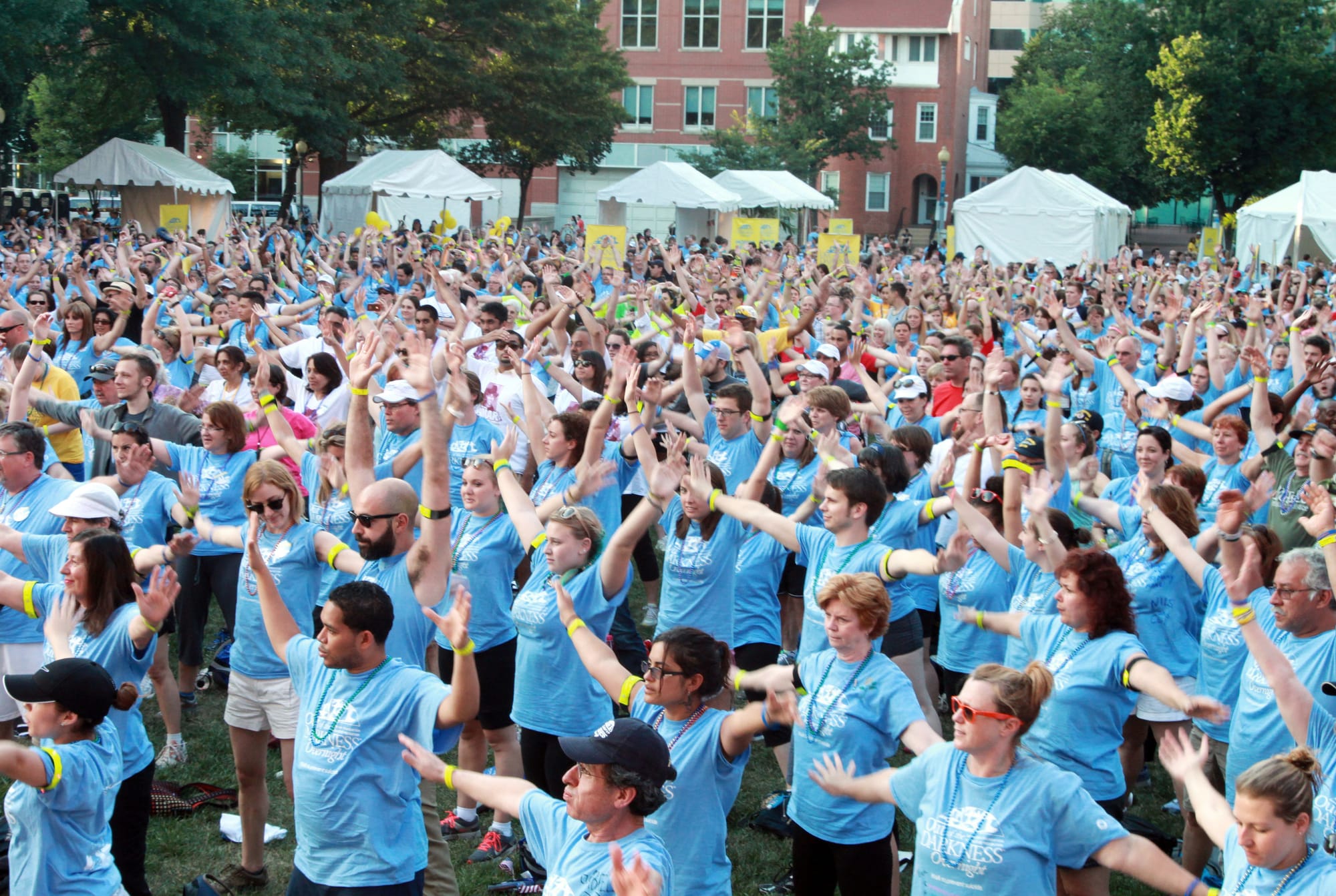 Walkers stretch to Zumba music before the Out of the Darkness Overnight Walk in Washington, D.C. June 1, 2013. The American Foundation for Suicide Prevention holds the annual walk to raise money for suicide awareness and prevention. About 2,000 walkers and volunteers participated this year.