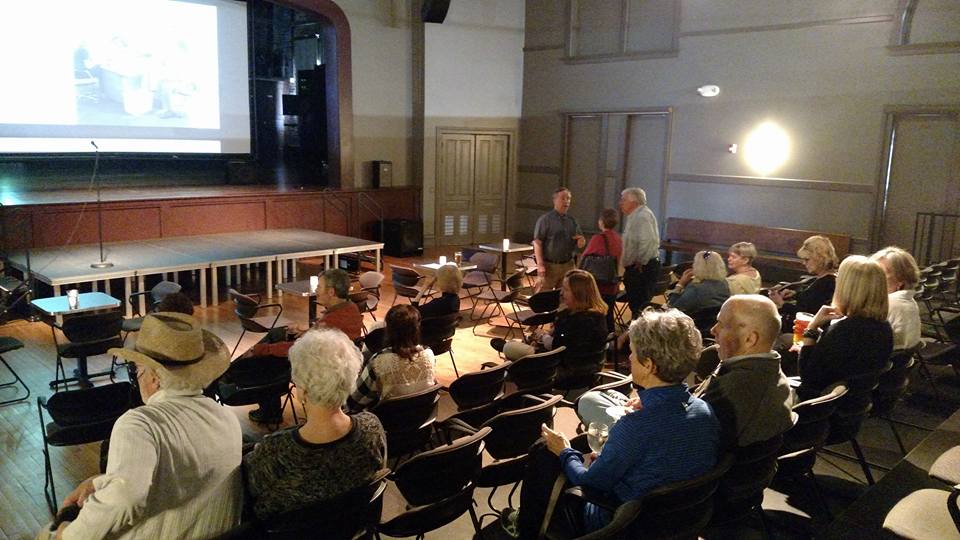 An audience in Cedar Rapids listens to former Boston Globe Spotlight reporter Matt Carroll talk via Skype on May 5, 2016, about the Oscar-winning movie about the Spotlight team's investigation into priest sex abuse.