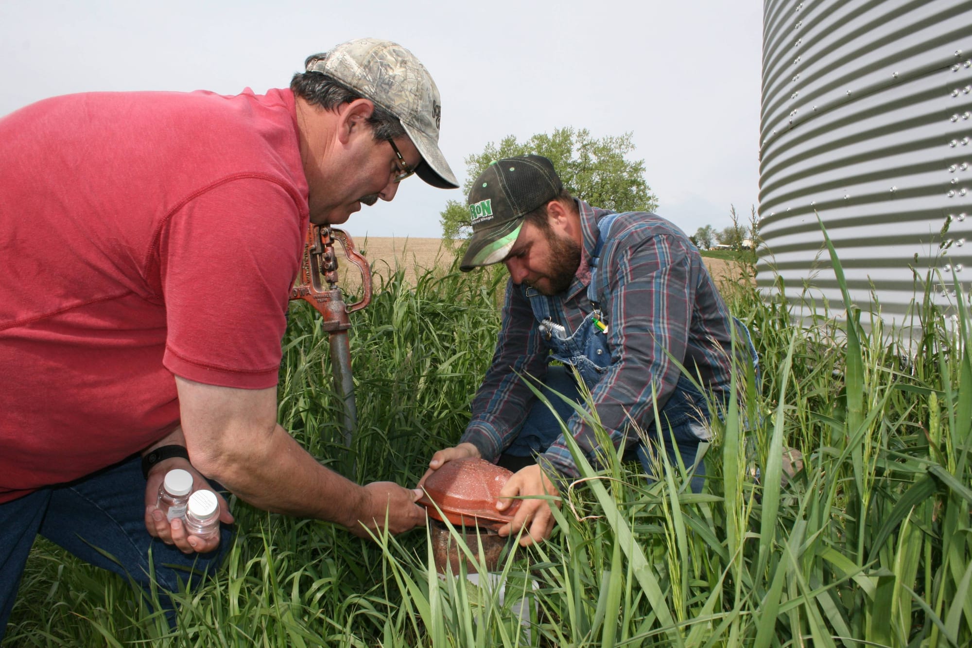 Mike Stringham, assistant sanitarian in Case, Audubon, Guthrie and Adair counties, looks at Wayne Royer’s well in Guthrie County on May 16, 2016. Royer’s doctor requested he get his well checked after he developed some gastrointestinal issues. Stringham estimated the well was from the 1950s and needed to be resealed around the top, where spiders had gotten in and built webs.