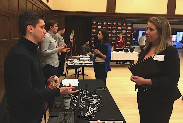 Taylor Tufte, an Iowa State University senior from Maple Grove, Minnesota, talks with a Bernstein-Rein job recruiter during a February 26, 2015, career fair for Iowa State journalism and communication students. Tuft says she fell in love with Iowa State after a visit to the school with a friend while in high school but doesn't want to stay in the state. She wants to live in a big city, she said.