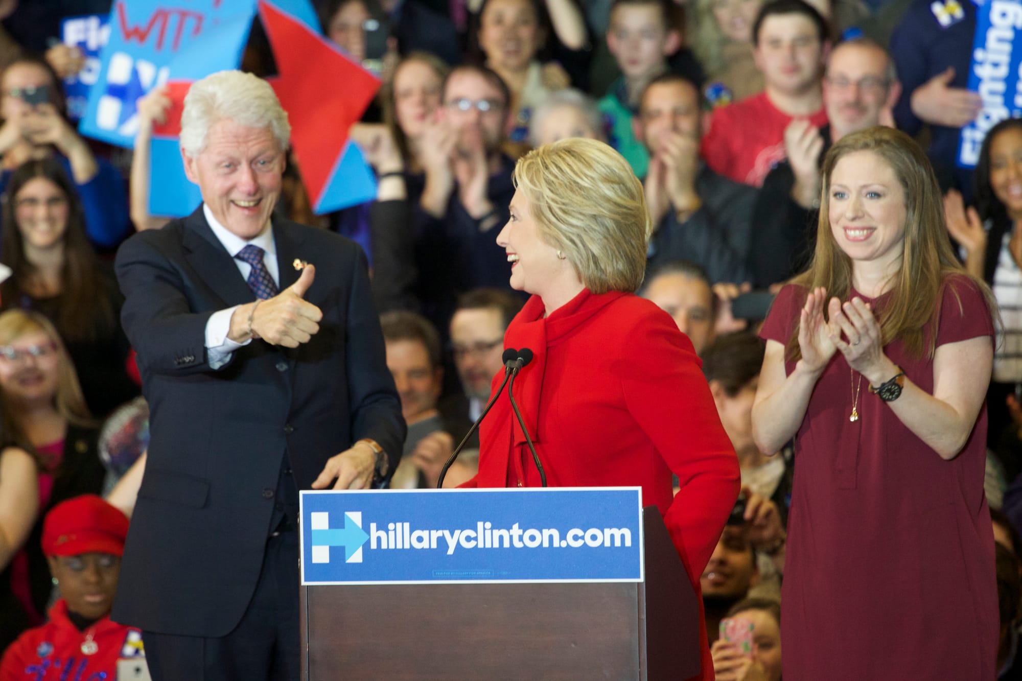 Husband and former President Bill Clinton gives wife and current presidential candidate Hillary Clinton a thumbs-up as she addresses a crowd of her supporters at Drake University in Des Moines, Iowa, after the Feb. 1, 2016, Iowa precinct caucuses. The couple's daughter, Chelsea Clinton, also was at the post-caucus rally.