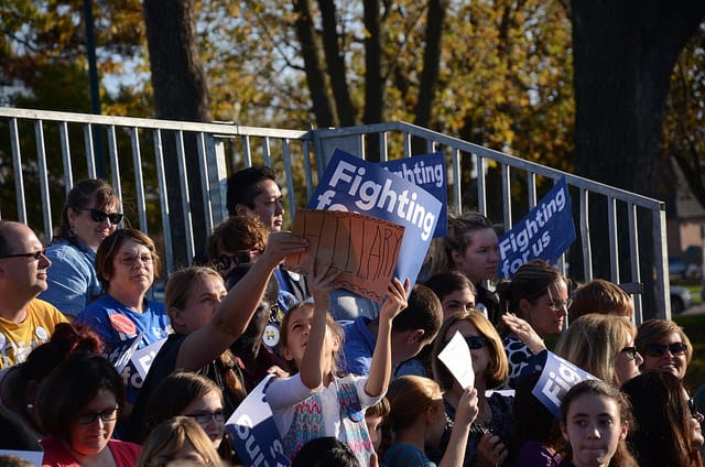 Two young girls show signs in support of Democrat Hillary Clinton during a Nov. 3, 2015, campaign stop in Coralville, Iowa.
