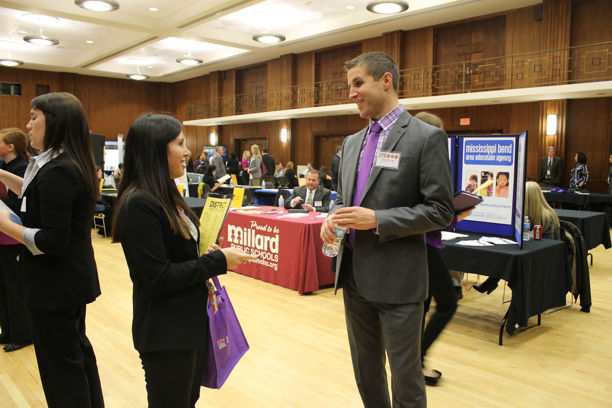 (Above) University of Iowa elementary education major Alyssa Makropoulos talks with Lucas Ptacek, the associate principal of Northwest Junior High School of Coralville, at a March 8, 2013, University of Iowa job fair. (Below) A student meets with the Waterloo Community School District’s director of support services, Larry Martin (left), and Expo Alternative Learning Center high school principal, Brenton Shavers, in a mock interview at the job fair.