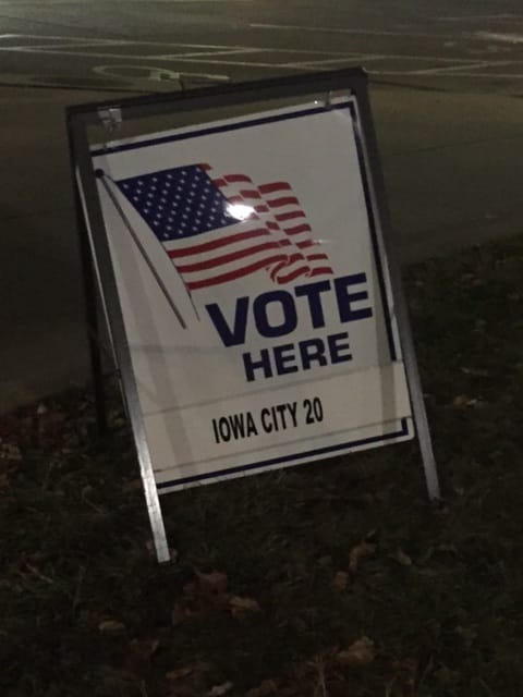 A Vote Here sign leads voters to a polling place in Iowa City on Nov. 8, 2016.