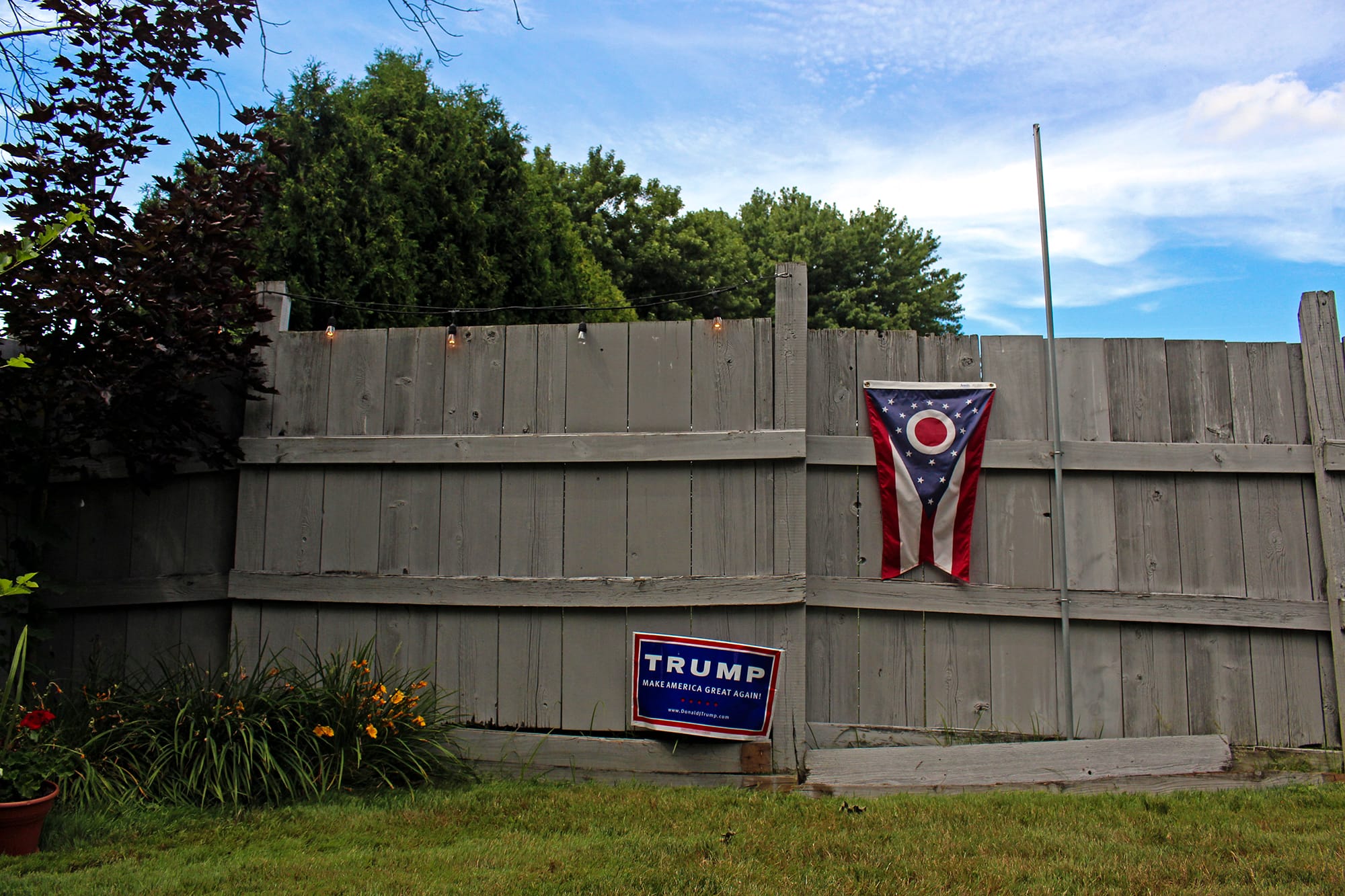 A Donald Trump campaign sign and Ohio state flag decorate the backyard of Kathy Miller, the Mahoning County chairwoman for Trump, in Boardman, Ohio. Miller is leading a grassroots movement encouraging Democratic voters to vote for Trump in November’s general election.