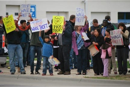 Protesters upset about unpaid wages gathered in front of the Outback Steakhouse in Cedar Rapids in May 2014.