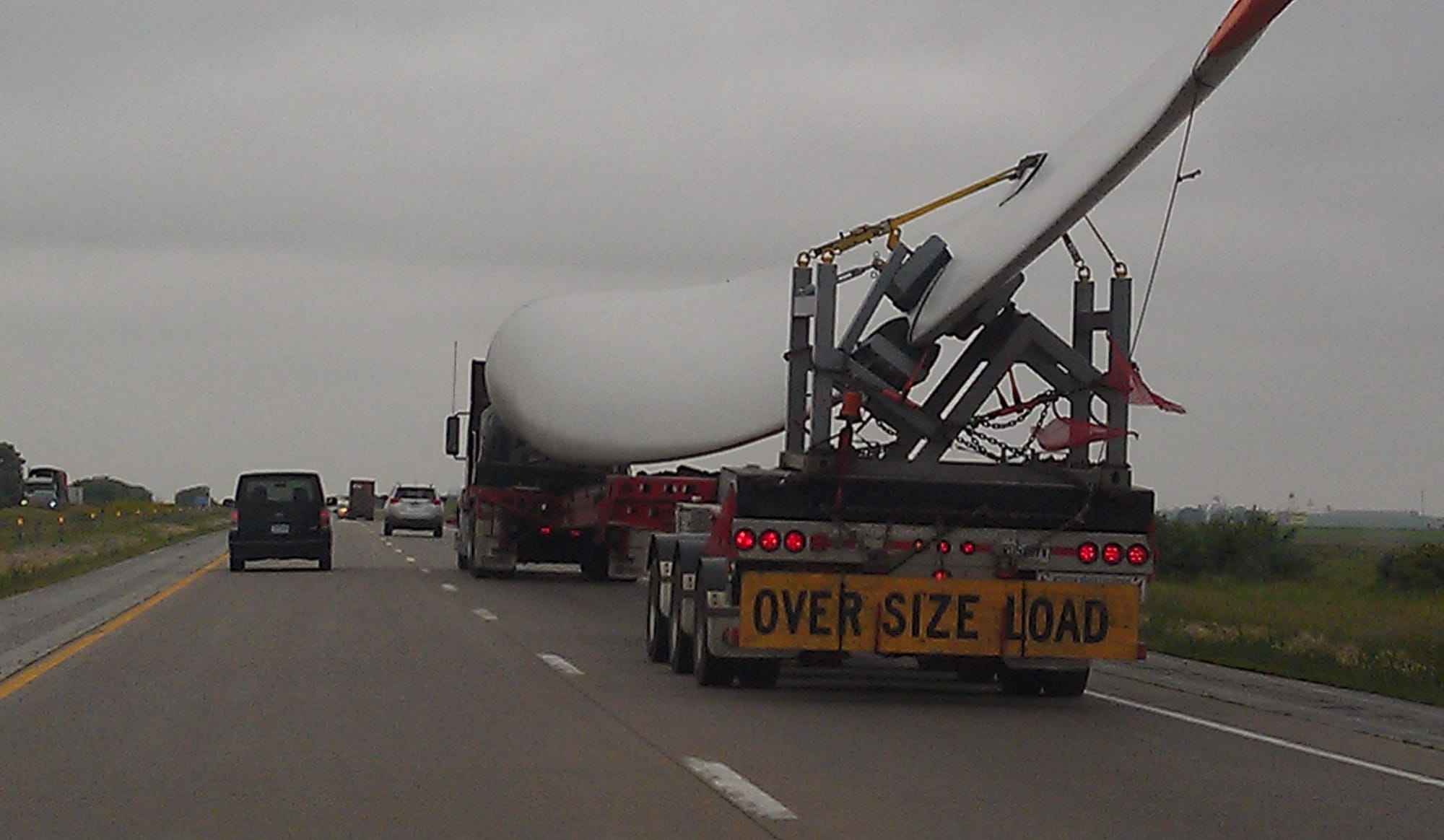 A truck hauls a wind tower blade on Interstate 80 west of Davenport, Iowa, in early June 2013.