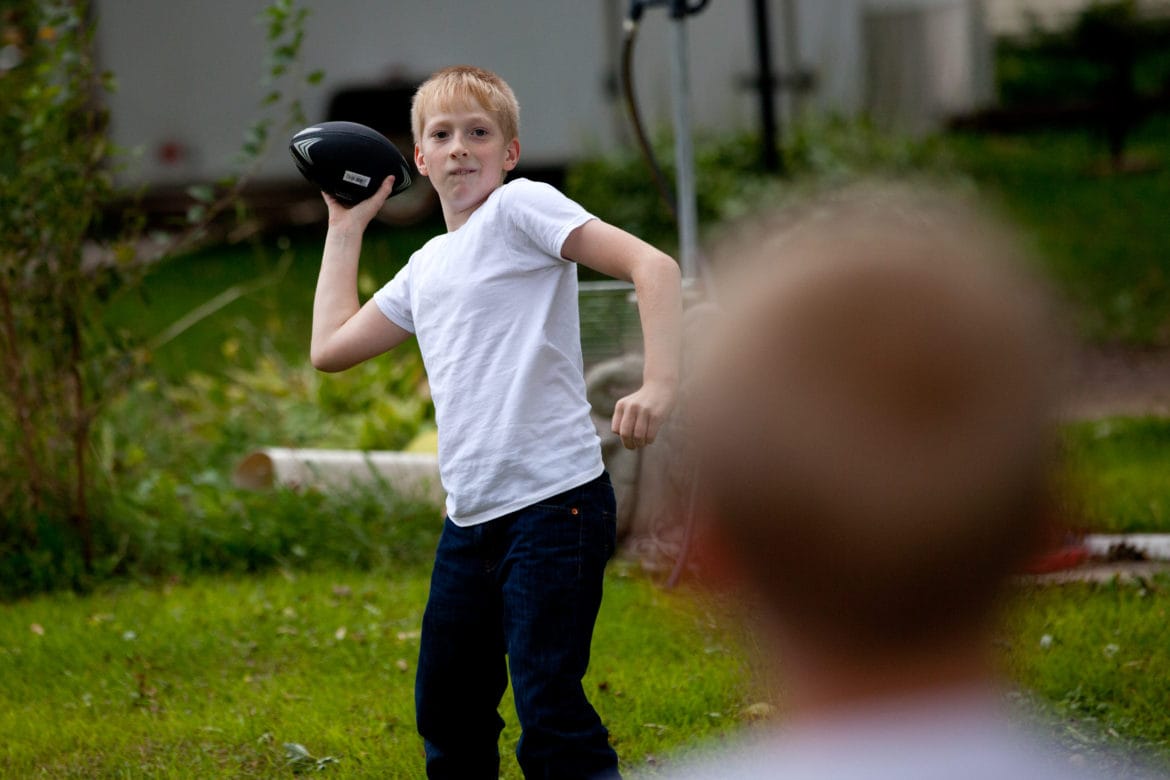 Jacob Reeves plays with his younger brother, Billy, foreground, at their home in rural Stoughton, Wis. In 2014, Jacob was diagnosed with juvenile dermatomyositis -- a rare disease that his mother Dawn attributes to the high level of atrazine found in their well water.