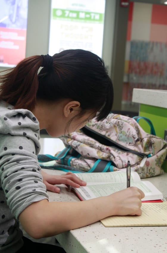 Yike Li, from China, spends most afternoons in fall 2013 at the University of Iowa Main Library, where she reads The New York Times and then sits in the commons area, memorizing GRE vocabulary words.