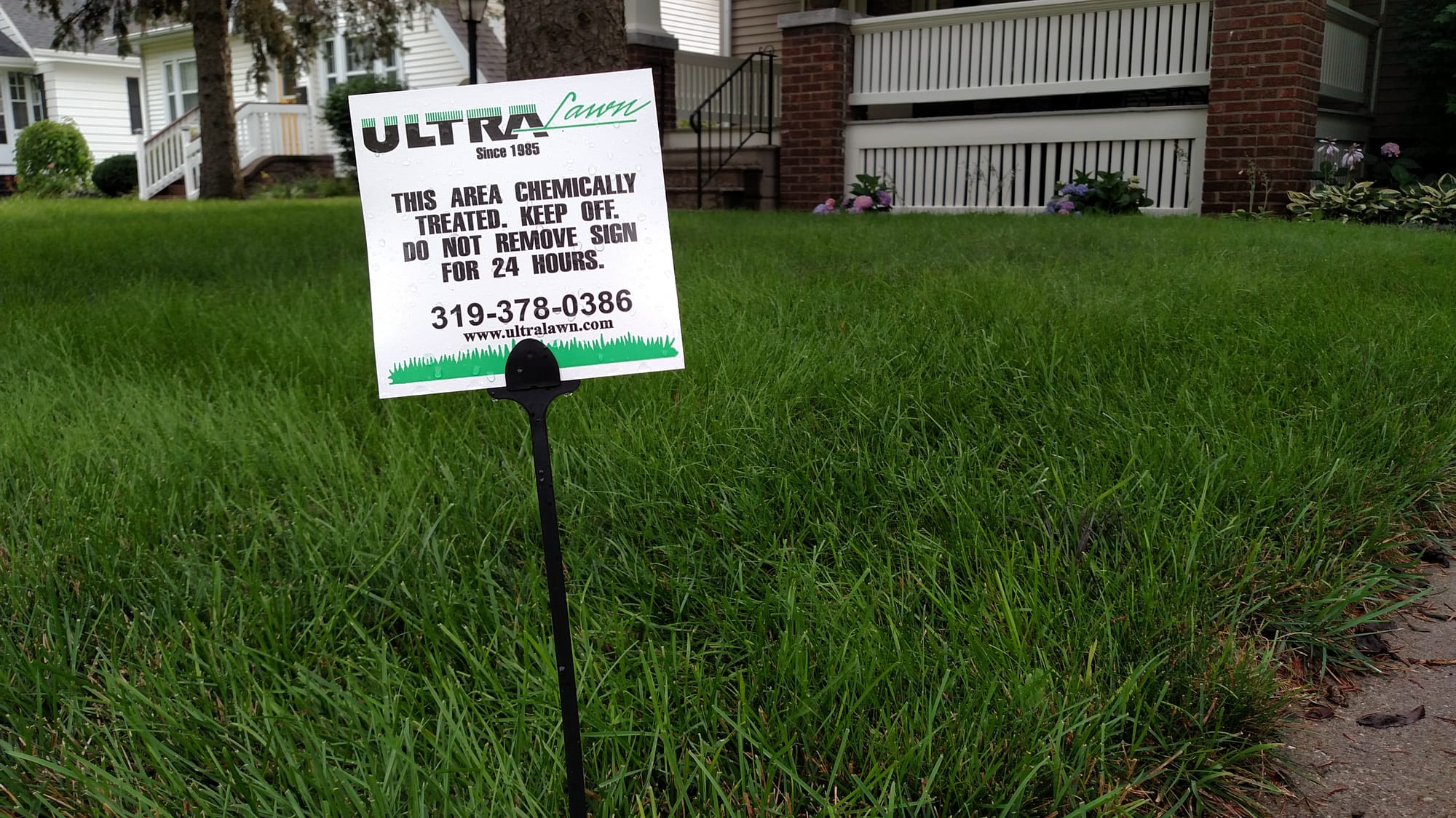 A sign warning people to stay off the lawn is shown in a Cedar Rapids yard following treatment on July 19, 2016.