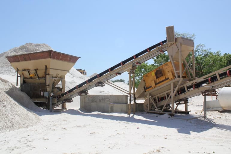 At Pattison Sand Co., seen here in 2011, fine-grained silica sand is funneled onto conveyor belts that move it through a giant, hissing rotary dryer, which uses heat to dry any wetness the sand retains after being washed. Some residents living around Pattison Sand’s proposed expansion at its site in Clayton County, Iowa, are concerned about being exposed to silica dust, which can cause lung damage if inhaled.