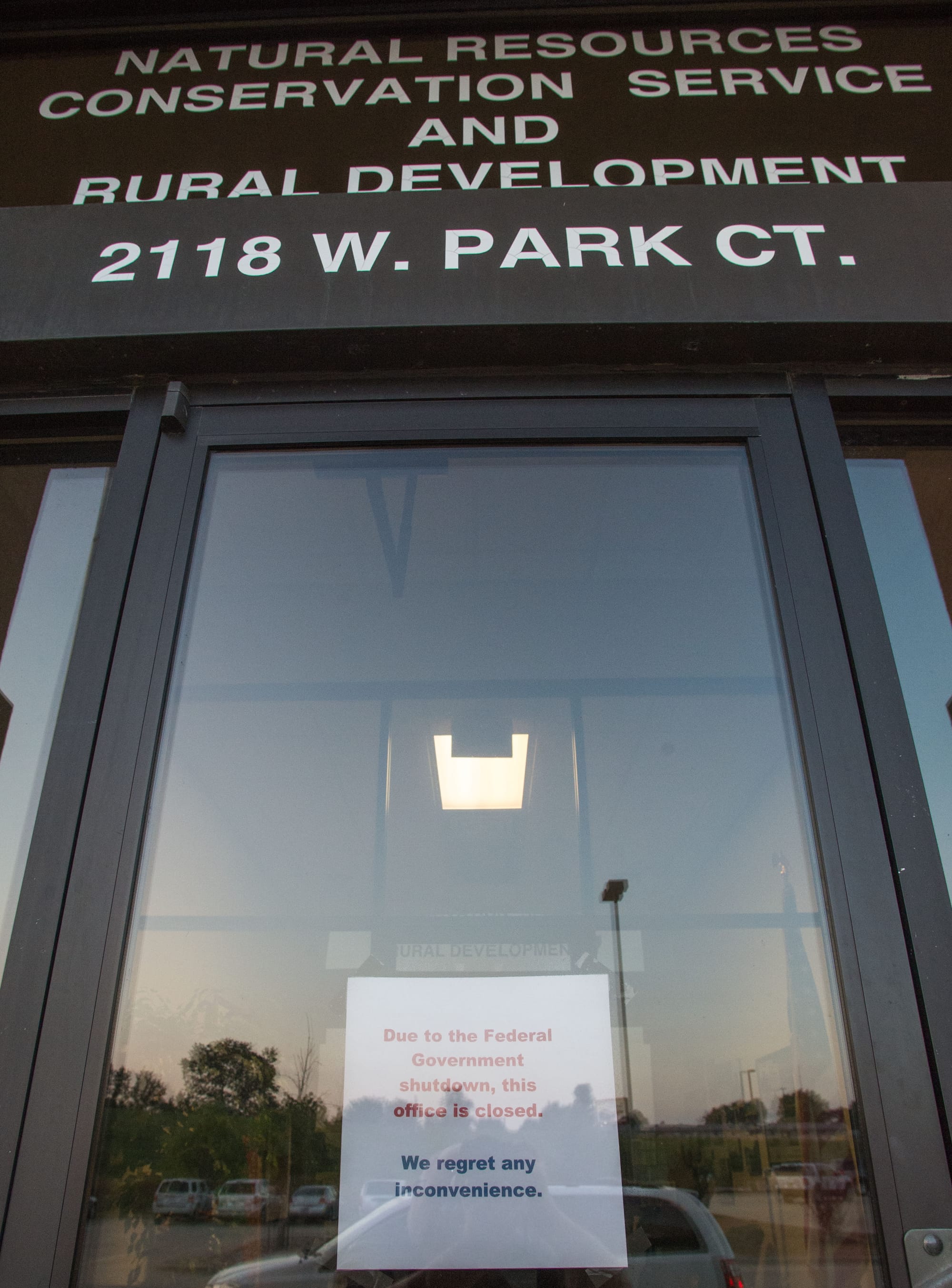 A sign explains the closed USDA offices in west Champaign, Ill., on Tuesday, Oct. 1, 2013. It reads: "Due to the Federal Government shutdown, this office is closed."