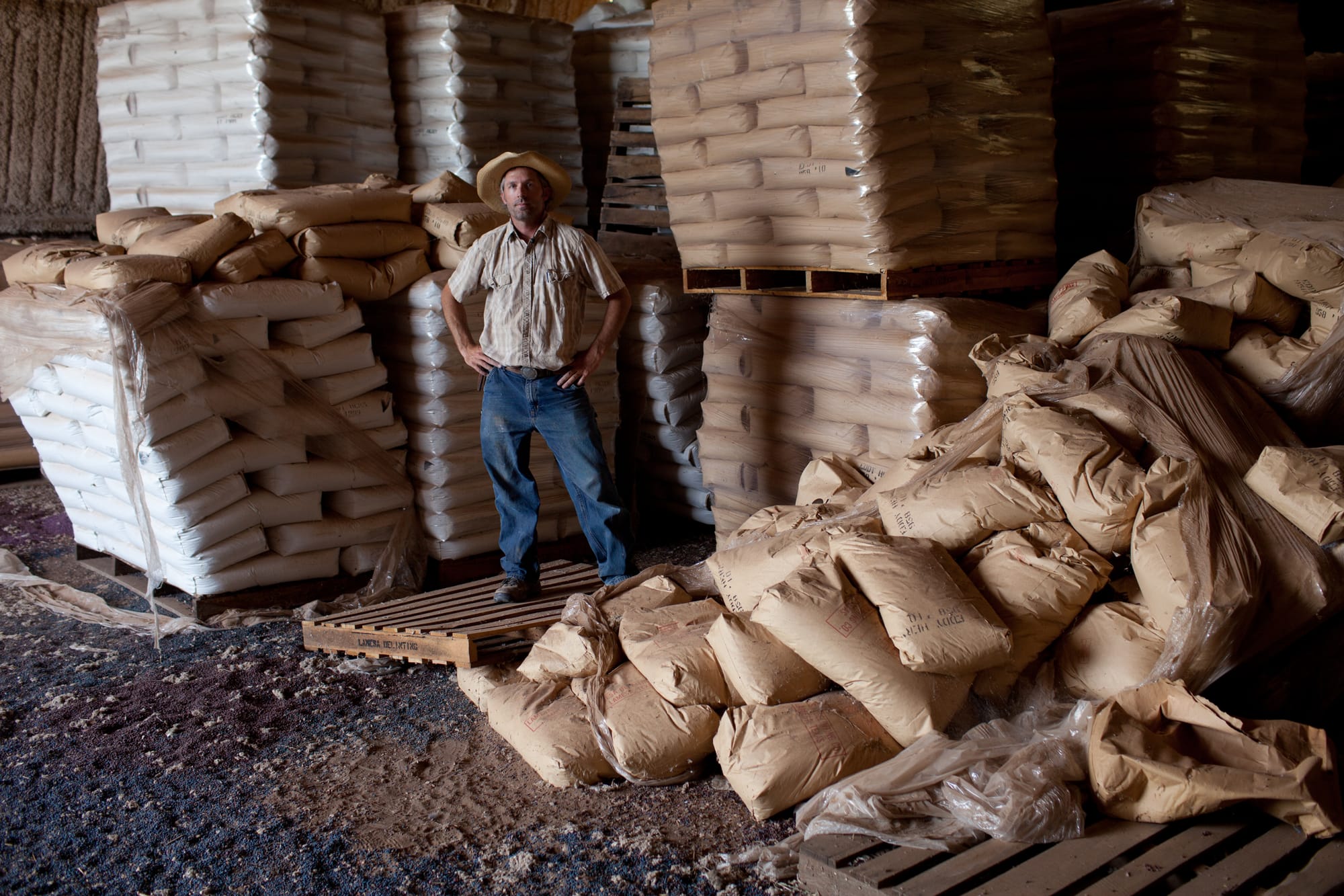 Eric Herm, 40, unloads non-gmo cotton seed into a storage barn. Herm call this his "Fort 