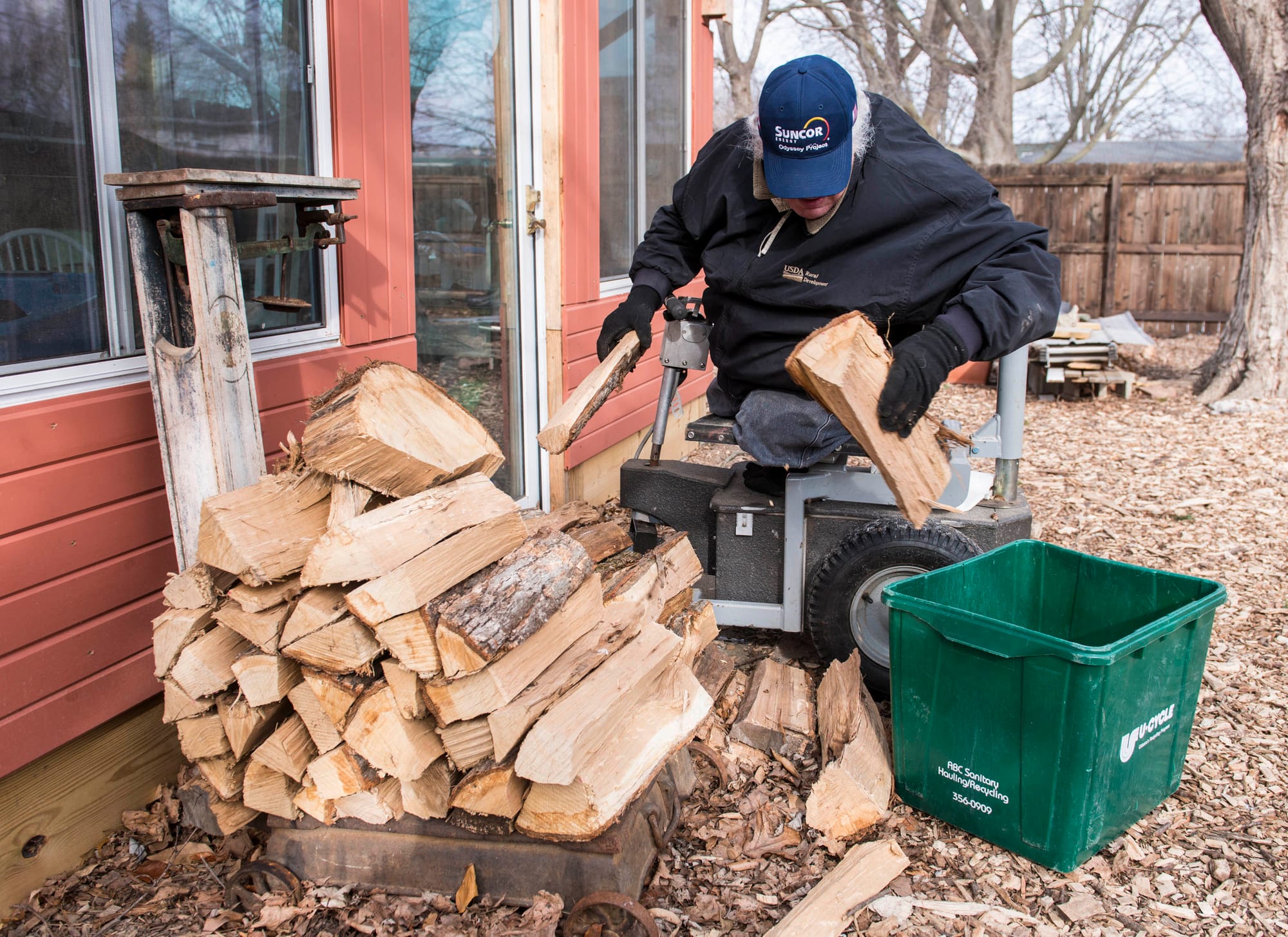 Chip Petrea moves wood in his backyard at home in Urbana, Ill., in January.