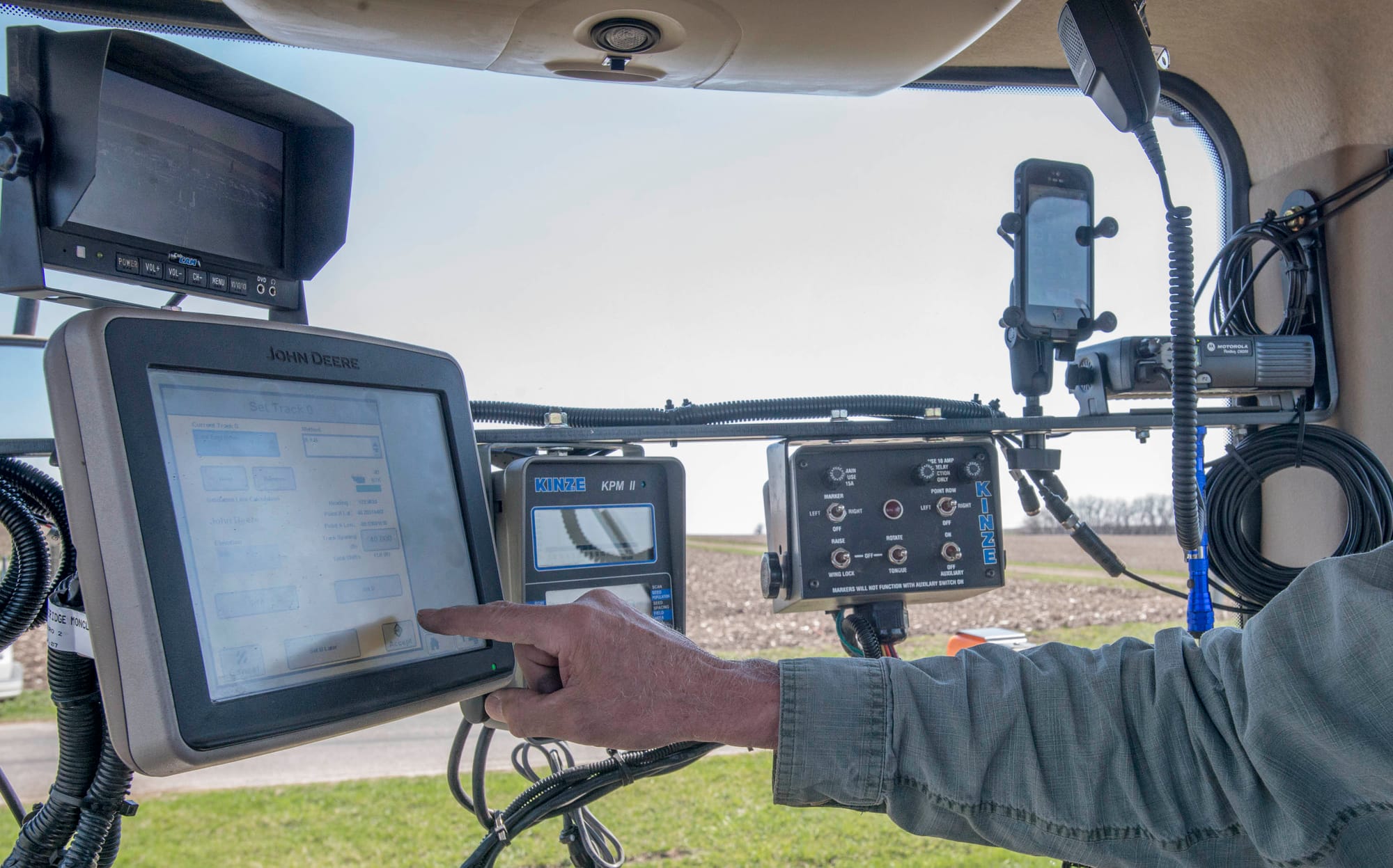 Farmer Craig Anderson of Mansfield, Ill., prepares his tractor's auto steer, which will navigate the machine during most of spring planting. Covering agribusiness requires reporters to learn about climatology, geology, economics and complex technology.