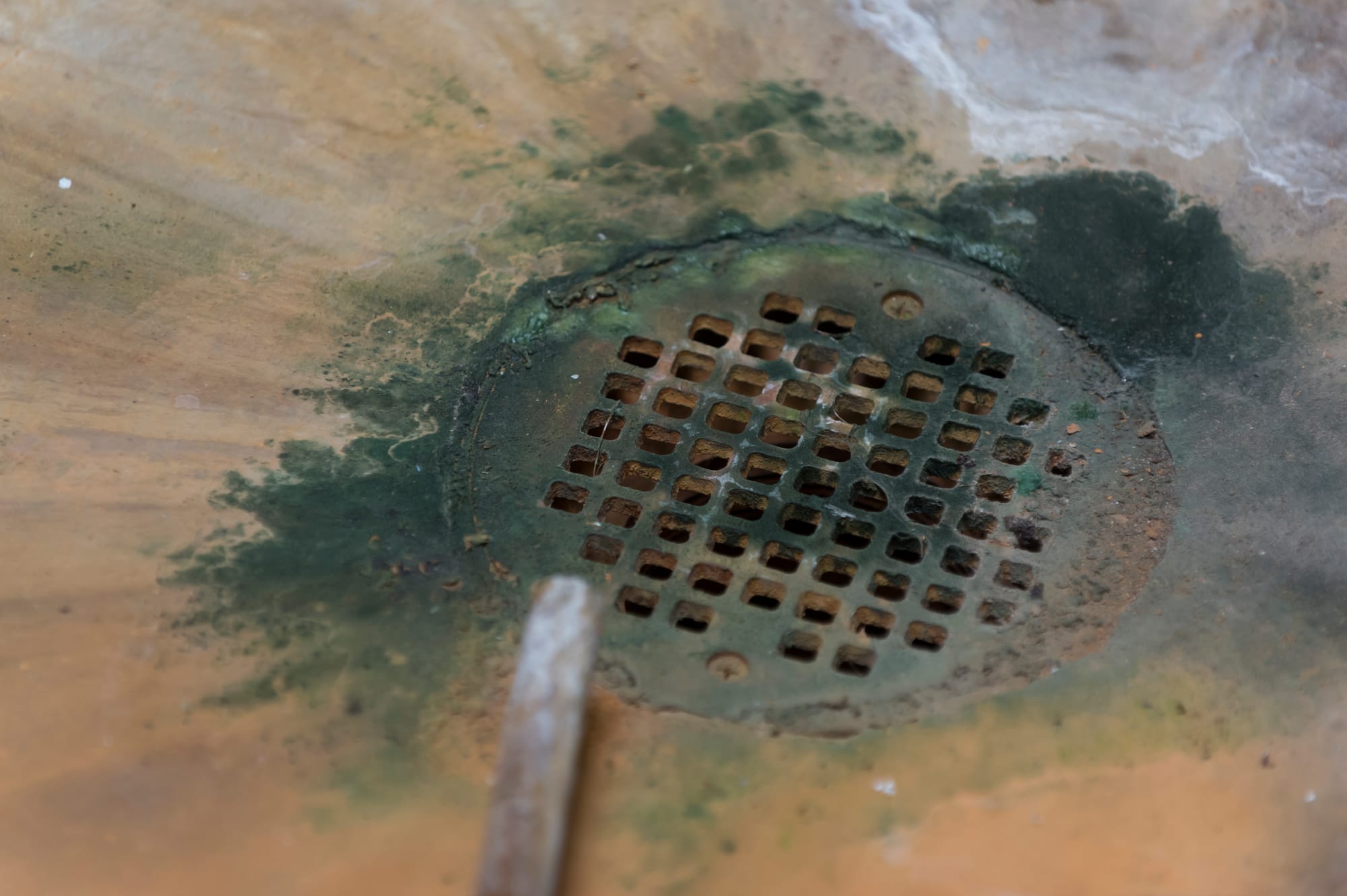 Iron sediment gathers around a drain. Each year, water utility companies spend hundreds of millions of dollars fixing water systems.