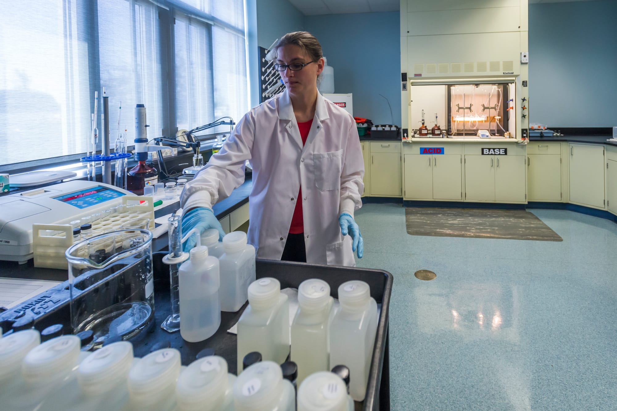 A water quality control technician checks samples in the lab  at the Illinois American Water plant west of Champaign, Ill.