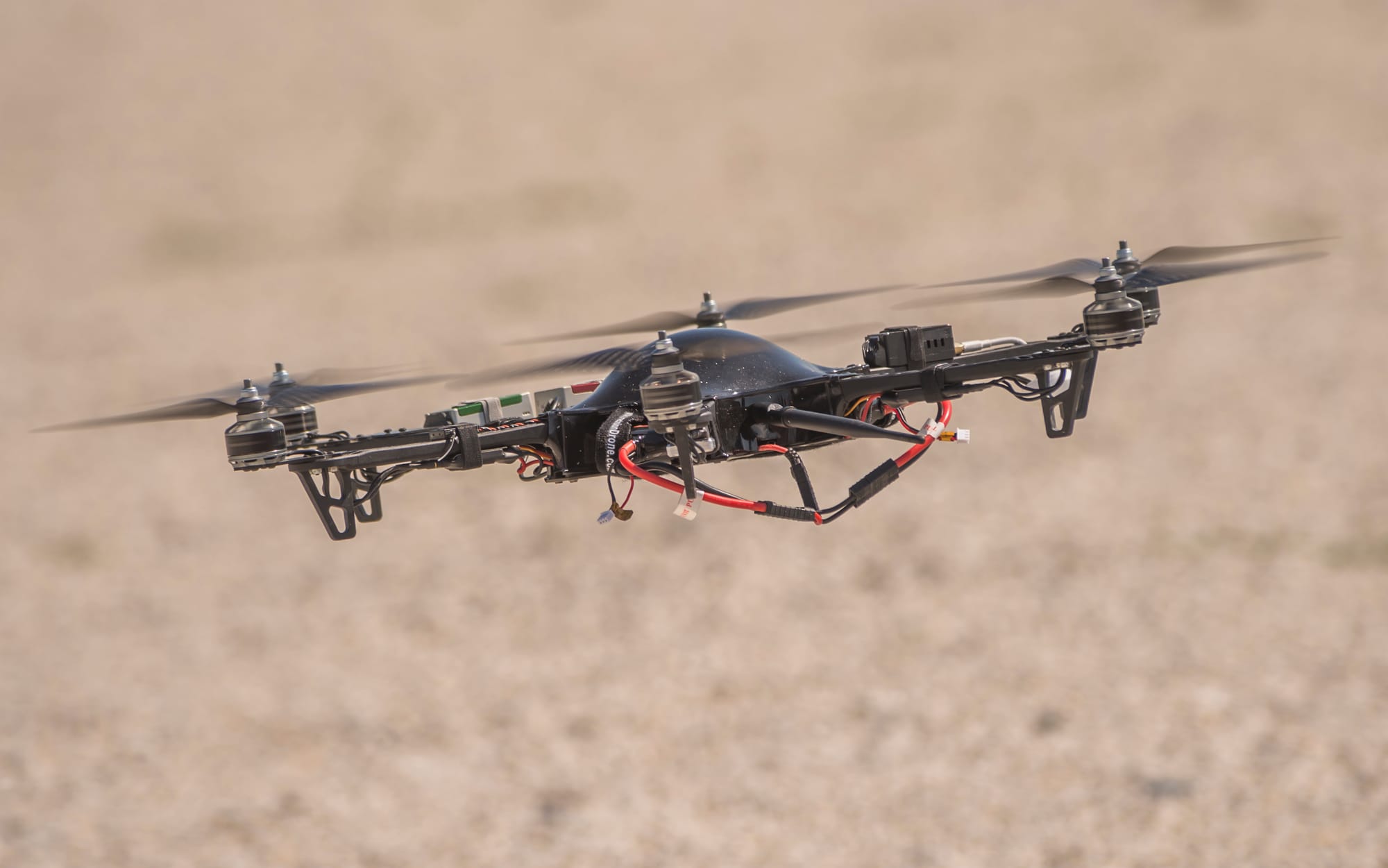 A Precision Drone aircraft hovers above the ground at the 2014 Precision Aerial Ag Show in Decatur, Ill. More than 1,000 farmers and enthusiasts attended the show, which demonstrated how growers can use drones on their farm.