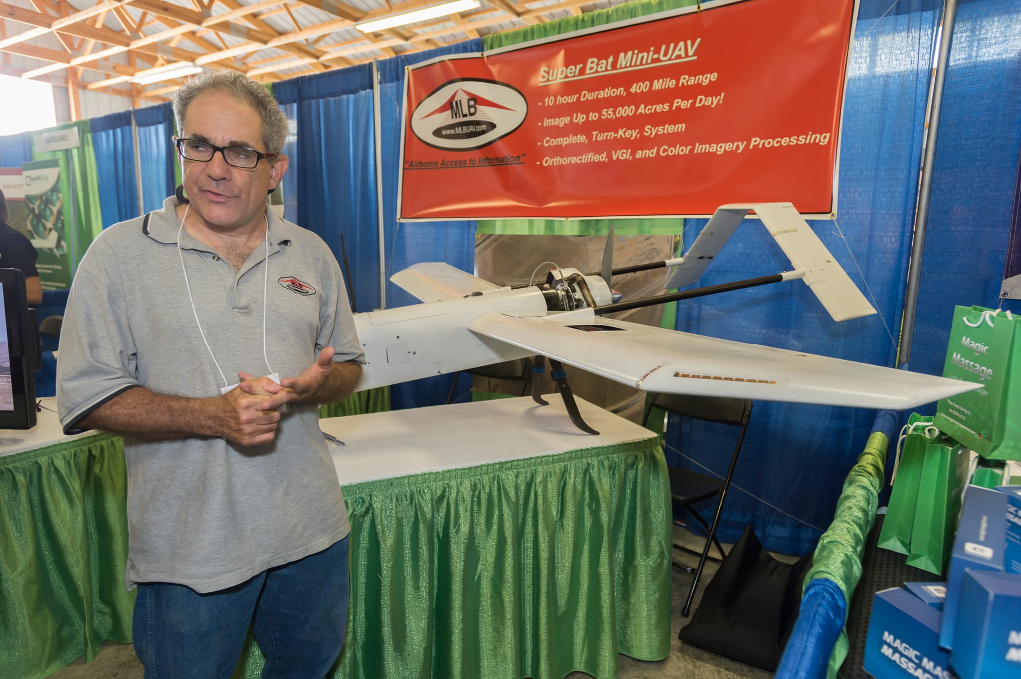 Stephen Morris, president of MLB Company, stands next to the Super Bat UAS at the 2014 Precision Aerial Ag Show in Decatur, Ill. The Super Bat UAS can reach altitudes of 15,000 feet and survey 55,000 acres of crops in one day.