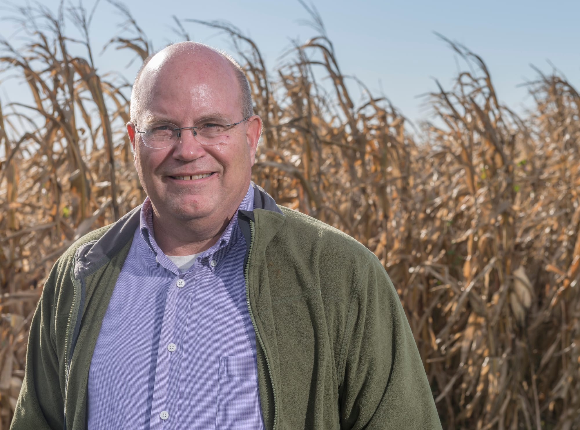 University of Illinois at Urbana-Champaign agricultural economist Gary Schnitkey stands in front of corn at a research plot on Oct. 17, 2014.