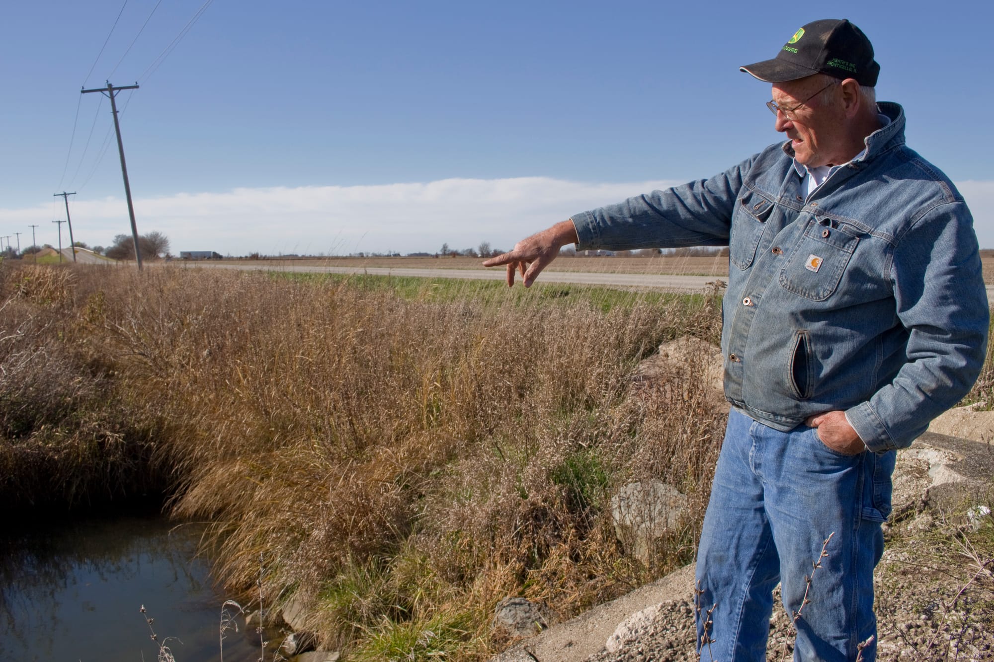 Lin Warfel points to a drainage area on his property on Nov. 5, 2014.