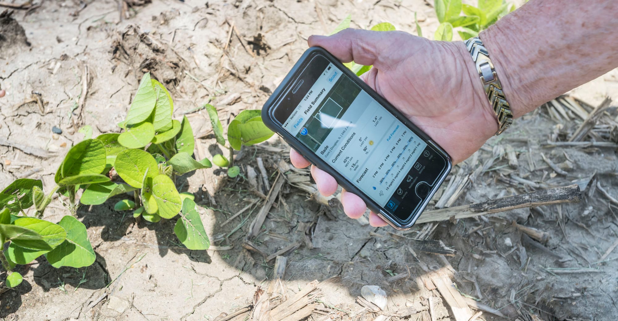 Apgar Farms representative Tom Austin demonstrates some of the data available on the Climate Corporation app used at the farm's operation near Tuscola, Ill., on June 10, 2015. Monsanto has pledged to become carbon neutral by 2021.
